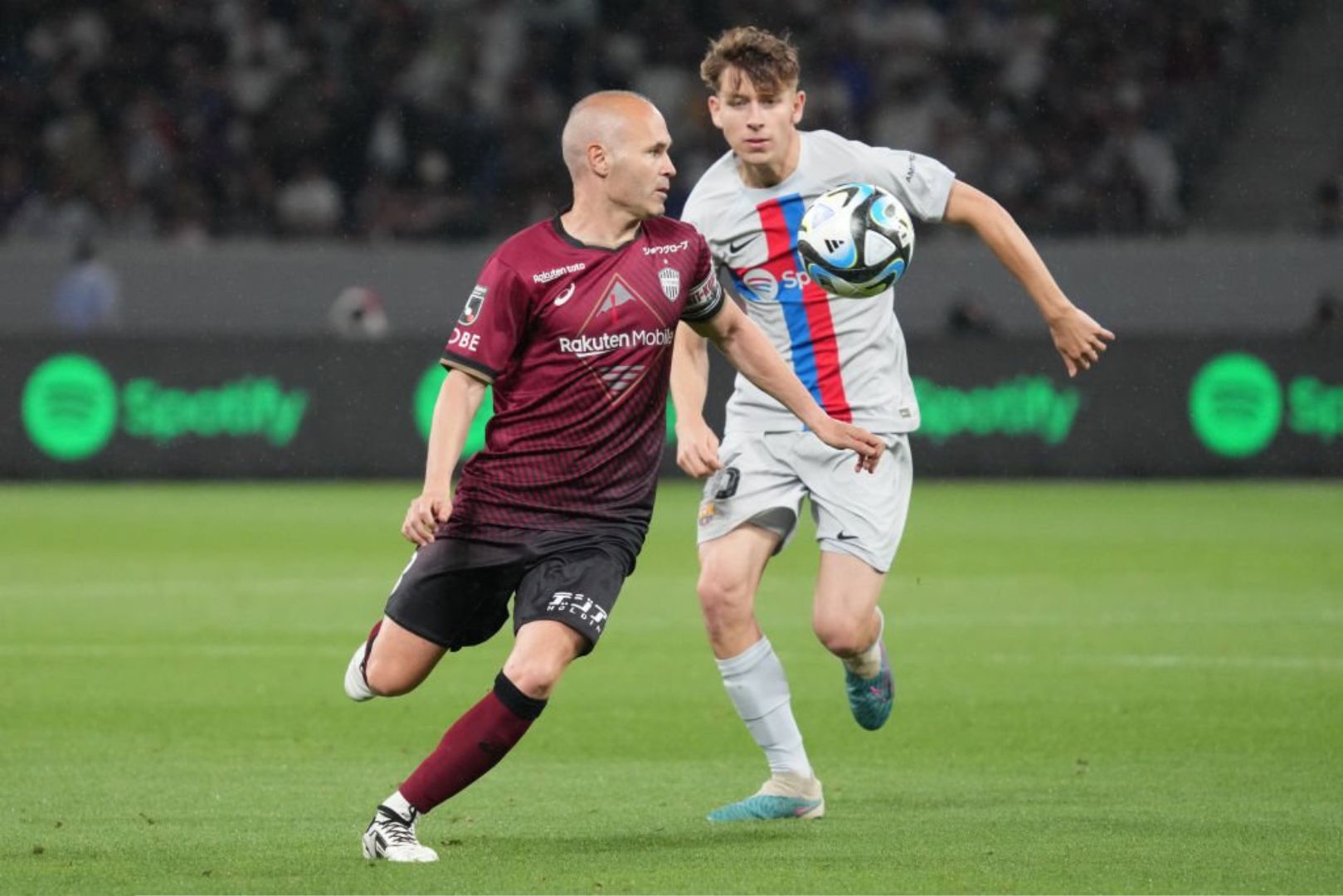 Barcelona youngster Pau Prim with Andrés Iniesta during a friendly match