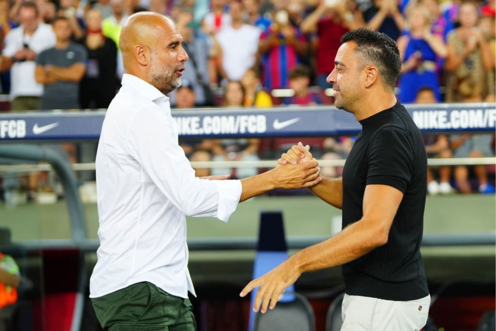Barcelona head coach Xavi with Man City head coach Pep