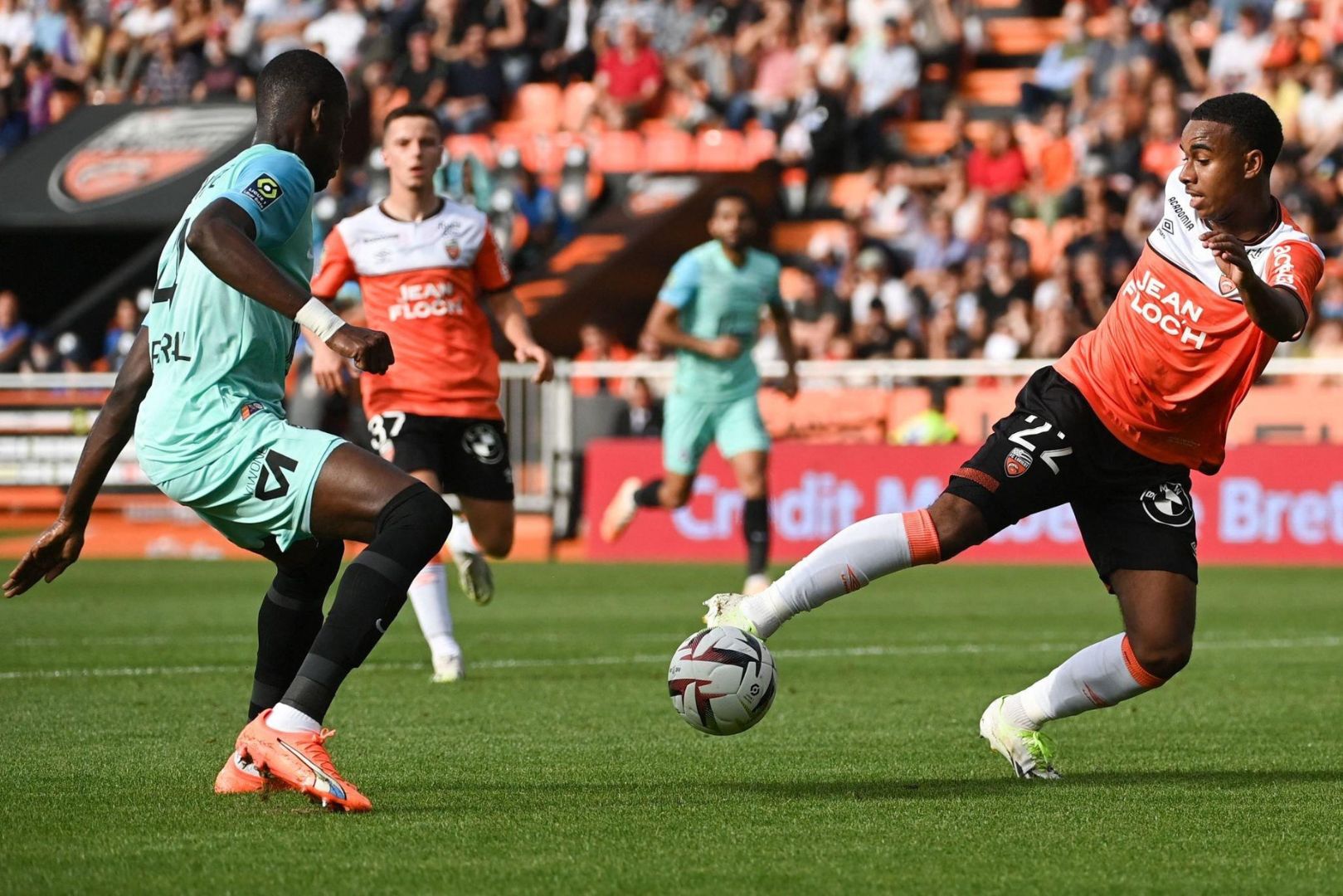Montpellier's Malian defender #04 Boubakar Kouyate (L) fights for the ball with Lorient's French forward #22 Eli Junior Kroupi during the French L1 football match between FC Lorient and Montpellier Herault Sport Club at Stade du Moustoir in Lorient, western France on October 1, 2023.