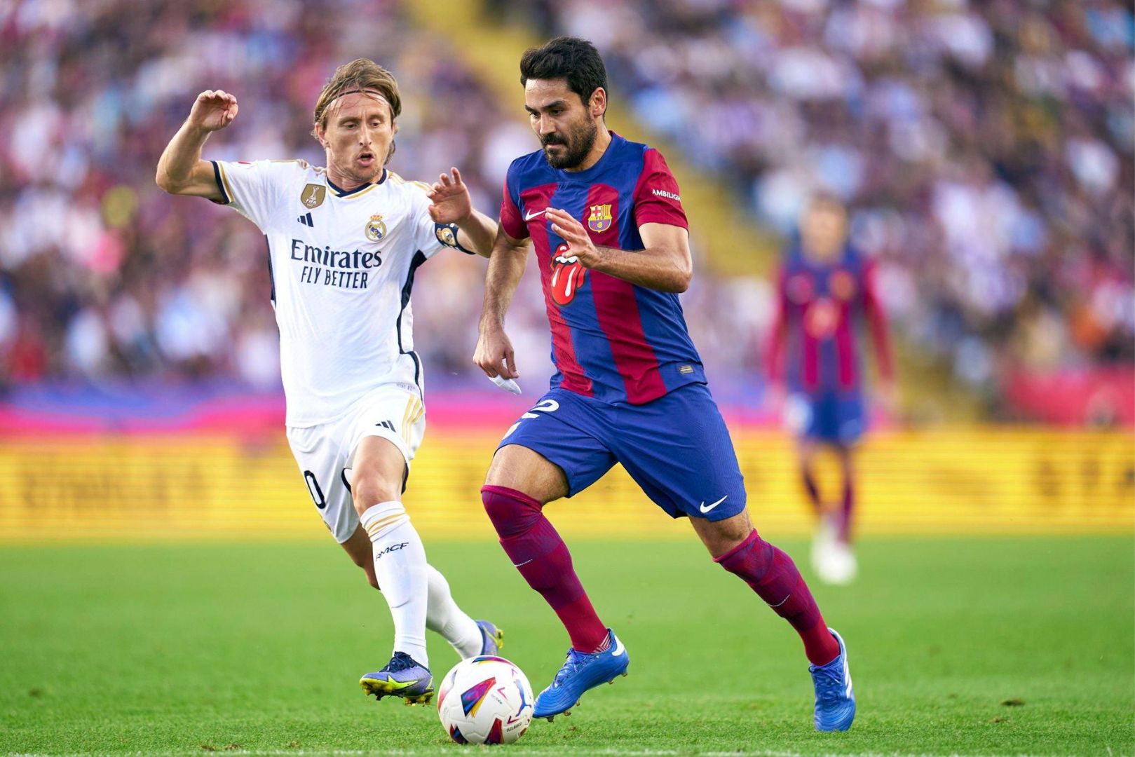 BARCELONA, SPAIN - OCTOBER 28: Ilkay Gundogan of FC Barcelona competes for the ball with Luka Modric of Real Madrid during the LaLiga EA Sports match between FC Barcelona and Real Madrid CF ( El Clasico ) at Estadi Olimpic Lluis Companys on October 28, 2023 in Barcelona, Spain.