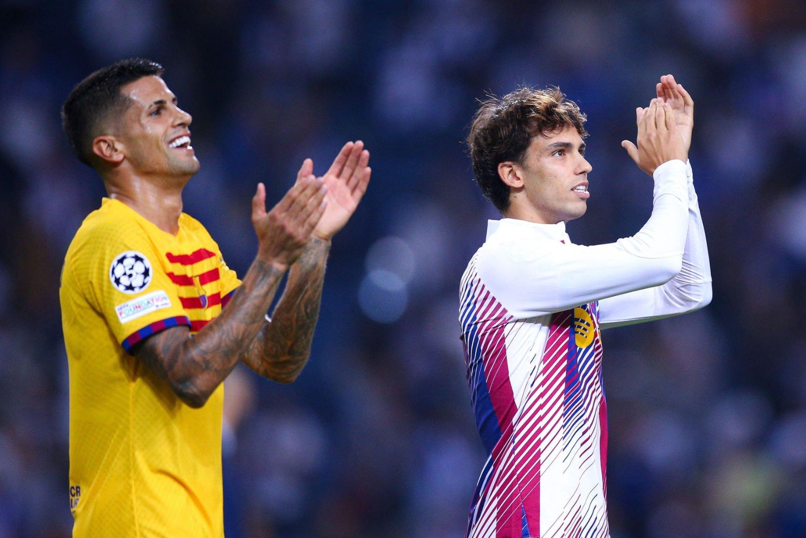 PORTO, PORTUGAL - OCTOBER 04: Joao Cancelo of FC Barcelona and Joao Felix of FC Barcelona gesture after the UEFA Champions League match between FC Porto and FC Barcelona at Estadio do Dragao on October 04, 2023 in Porto, Portugal.