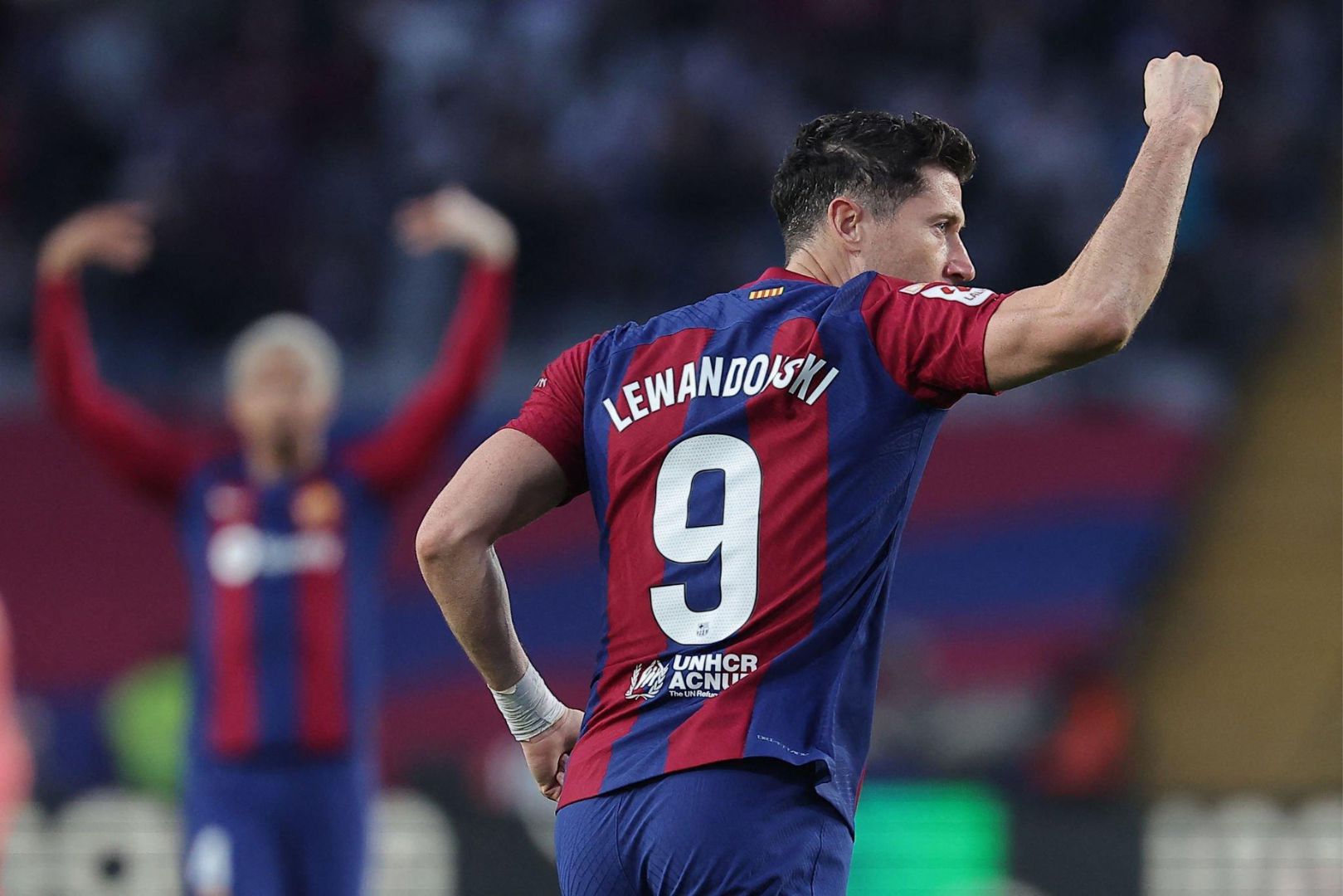Barcelona's Polish forward #09 Robert Lewandowski celebrates scoring his team's first goal during the Spanish league football match between FC Barcelona and Deportivo Alaves at the Estadi Olimpic Lluis Companys in Barcelona on November 12, 2023.