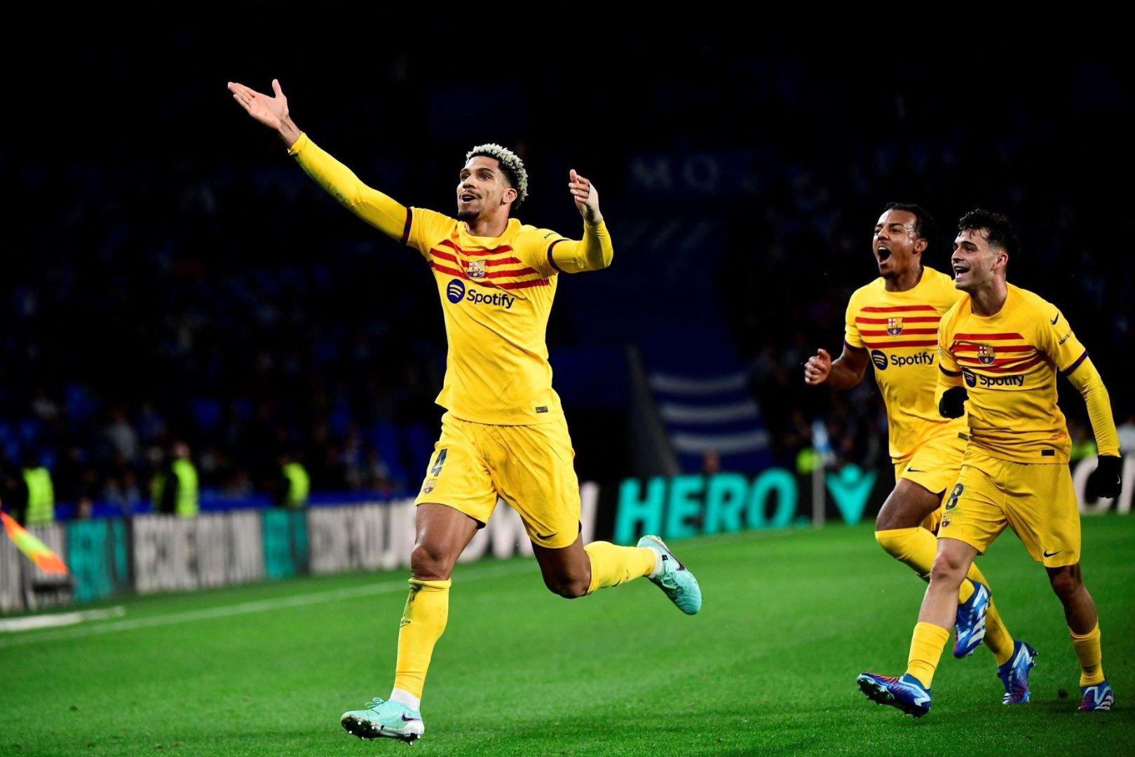 Barcelona's Uruguayan defender #04 Ronald Araujo celebrates with teammates scoring his team's first goal during the Spanish league football match between Real Sociedad and FC Barcelona at the Anoeta stadium in San Sebastian on November 4, 2023.