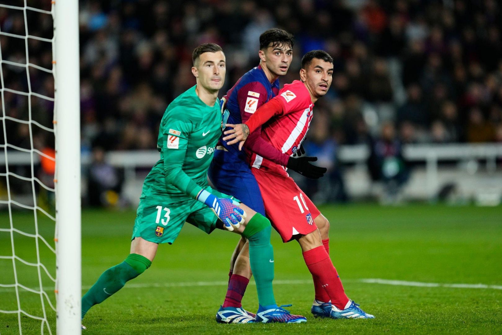 Iñaki Peña goalkeeper of Barcelona and Spain and Pedri central midfield of Barcelona and Spain and Angel Correa right winger of Atletico de Madrid and Argentina during the LaLiga EA Sports match between FC Barcelona and Atletico Madrid at Estadi Olimpic Lluis Companys on December 3, 2023 in Barcelona, Spain.