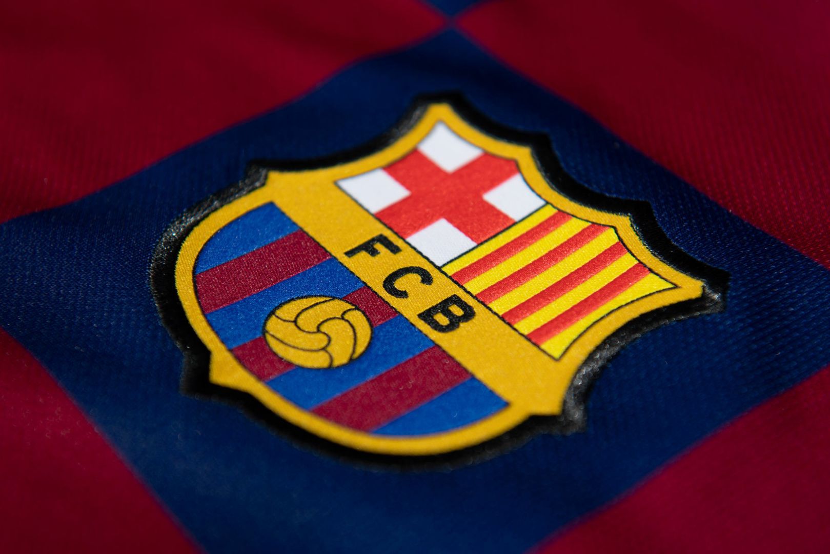 The FC Barcelona club crest on the first team home shirt on July 19, 2020 in Manchester, United Kingdom.