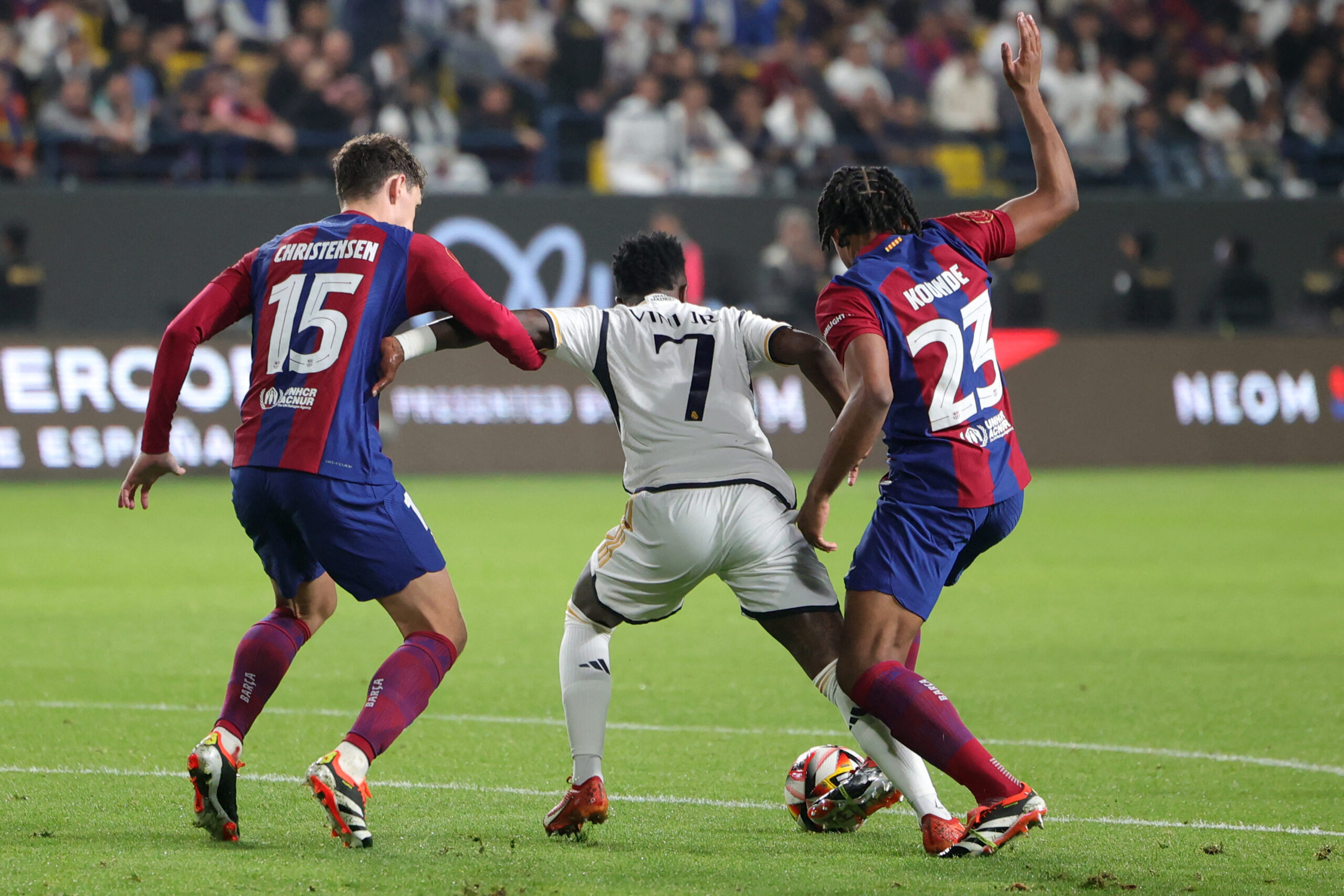 Barcelona's Danish defender #15 Andreas Christensen and French defender #23 Jules Kounde challenge Real Madrid's Brazilian forward #07 Vinicius Junior for the ball during the Spanish Super Cup final football match between Real Madrid and Barcelona at the Al-Awwal Park Stadium in Riyadh, on January 14, 2024.