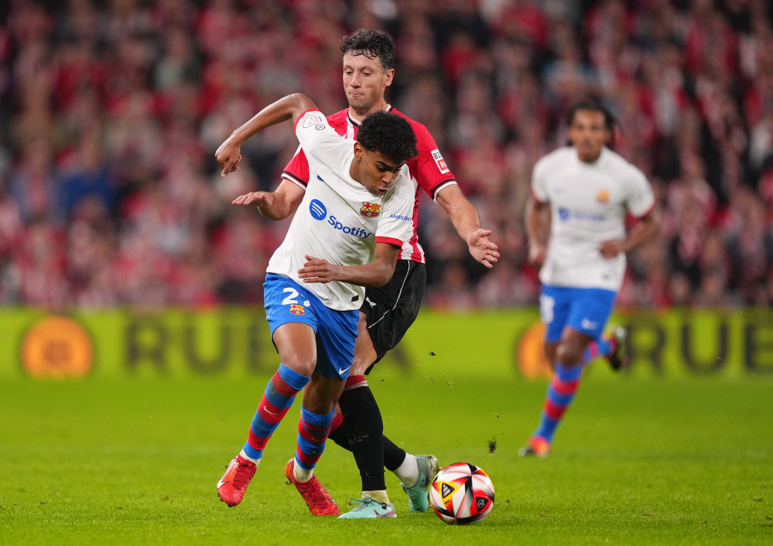 BILBAO, SPAIN - JANUARY 24: Lamine Yamal of FC Barcelona is challenged by Mikel Vesga of Athletic Club during the Copa del Rey Quarter Final match between Athletic Club and FC Barcelona at San Mames Stadium on January 24, 2024 in Bilbao, Spain.