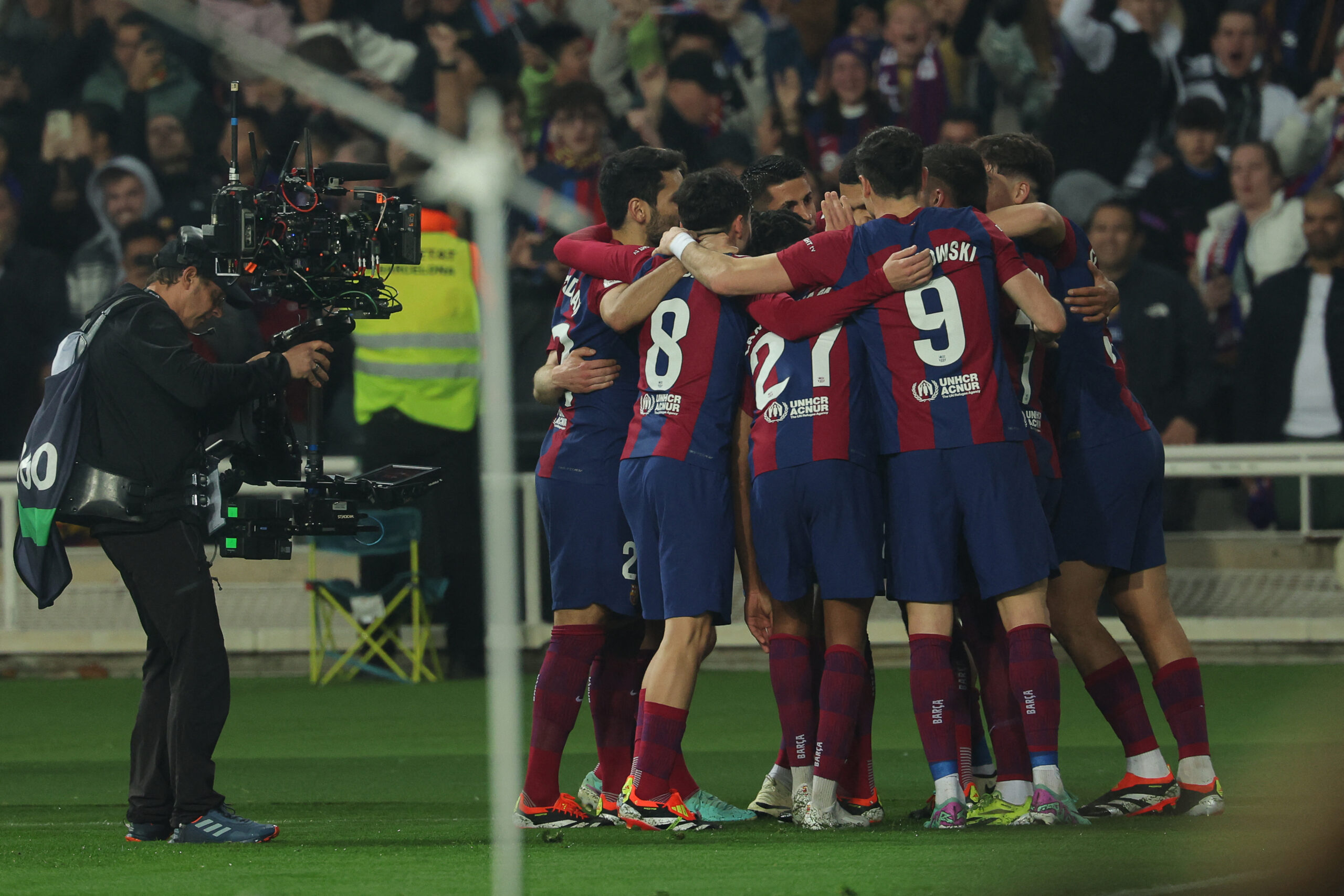 Barcelona's Uruguayan defender #04 Ronald Araujo celebrates with teammates after scoring his team's third goal during the Spanish league football match between FC Barcelona and Villarreal CF at the Estadi Olimpic Lluis Companys in Barcelona on January 27, 2024.