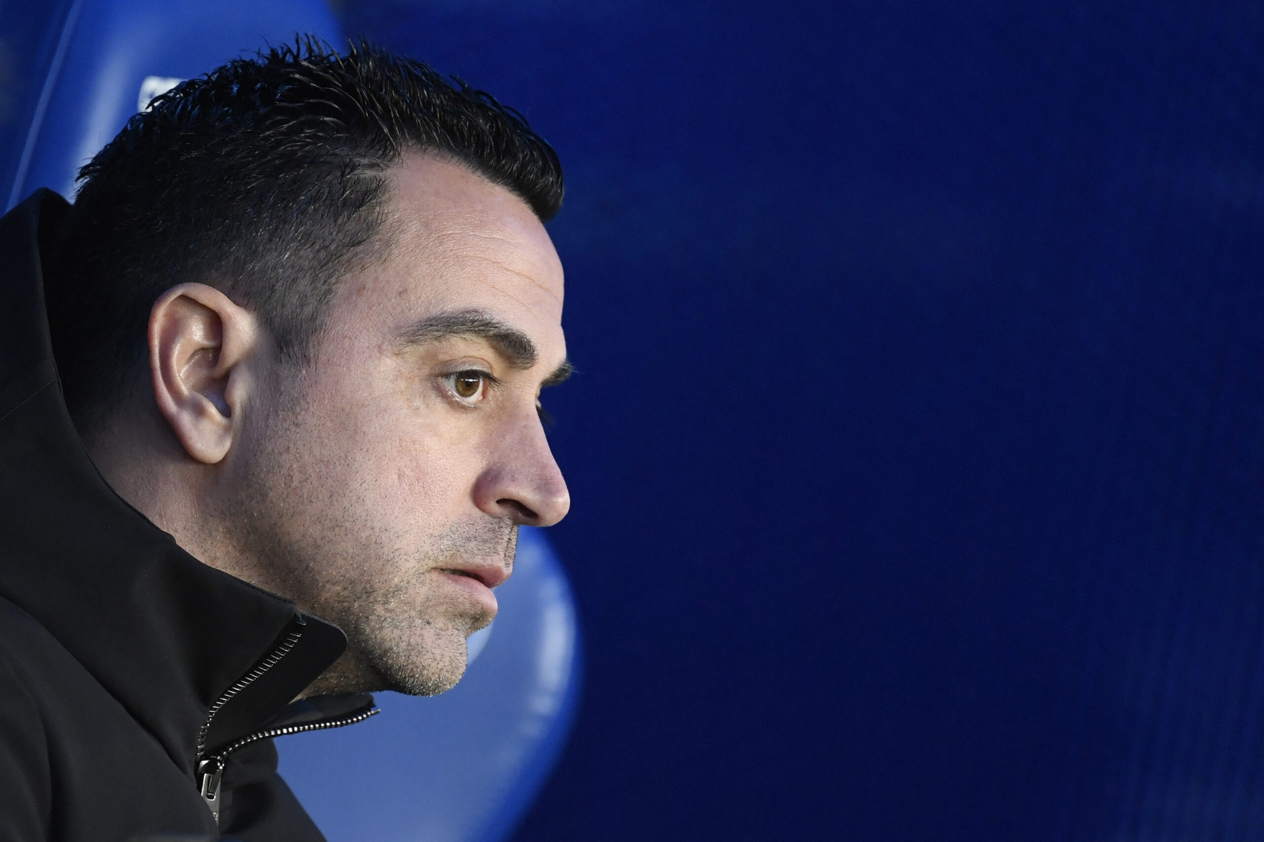 Barcelona's Spanish coach Xavi is pictured sitting on the bench prior to the Spanish league football match between Deportivo Alaves and FC Barcelona at the Mendizorroza stadium in Vitoria on February 3, 2024.