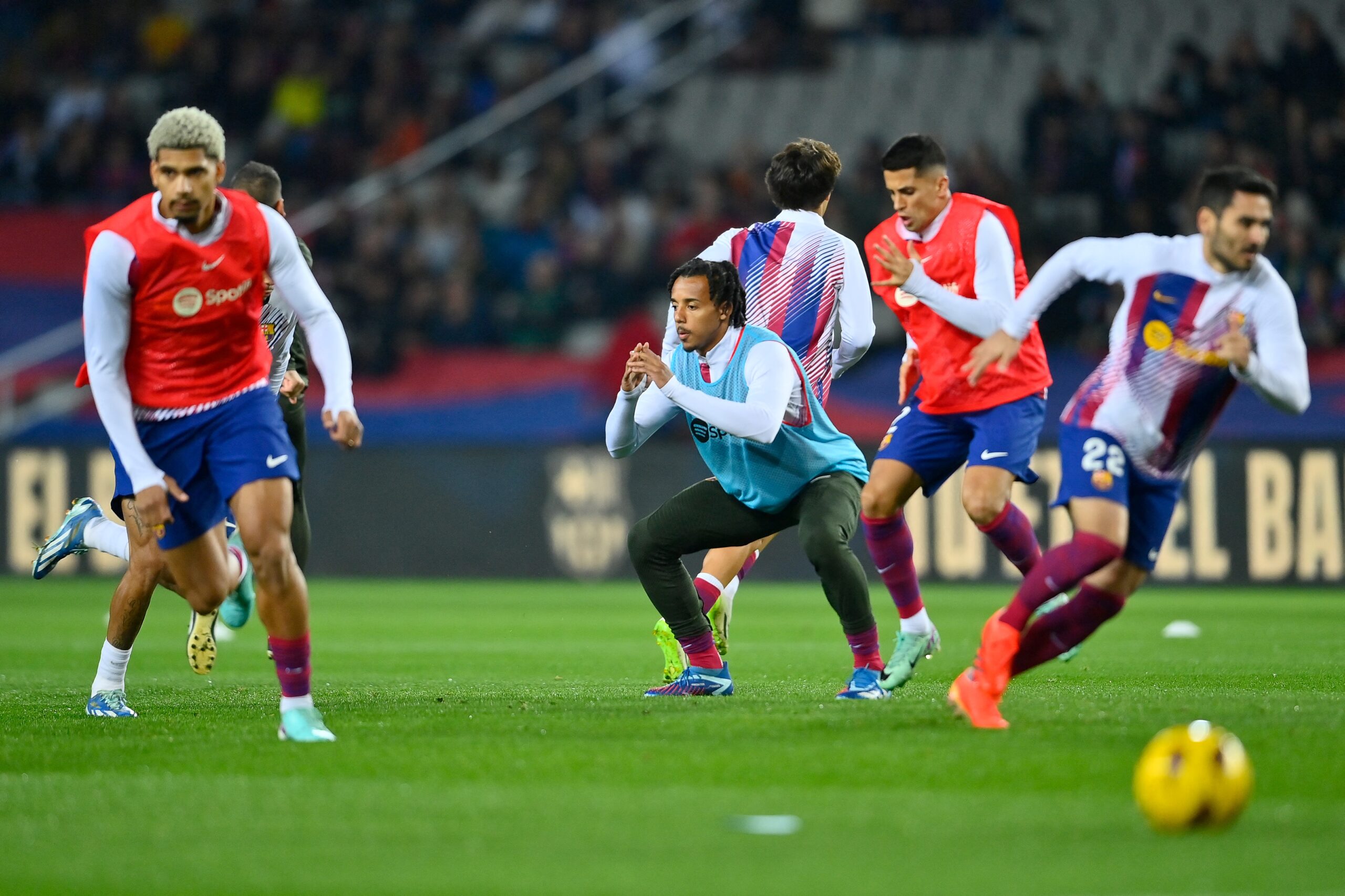 Barcelona's French defender #23 Jules Kounde (C) warms up before the start of the Spanish league football match between FC Barcelona and Girona FC at the Estadi Olimpic Lluis Companys in Barcelona on December 10, 2023.
