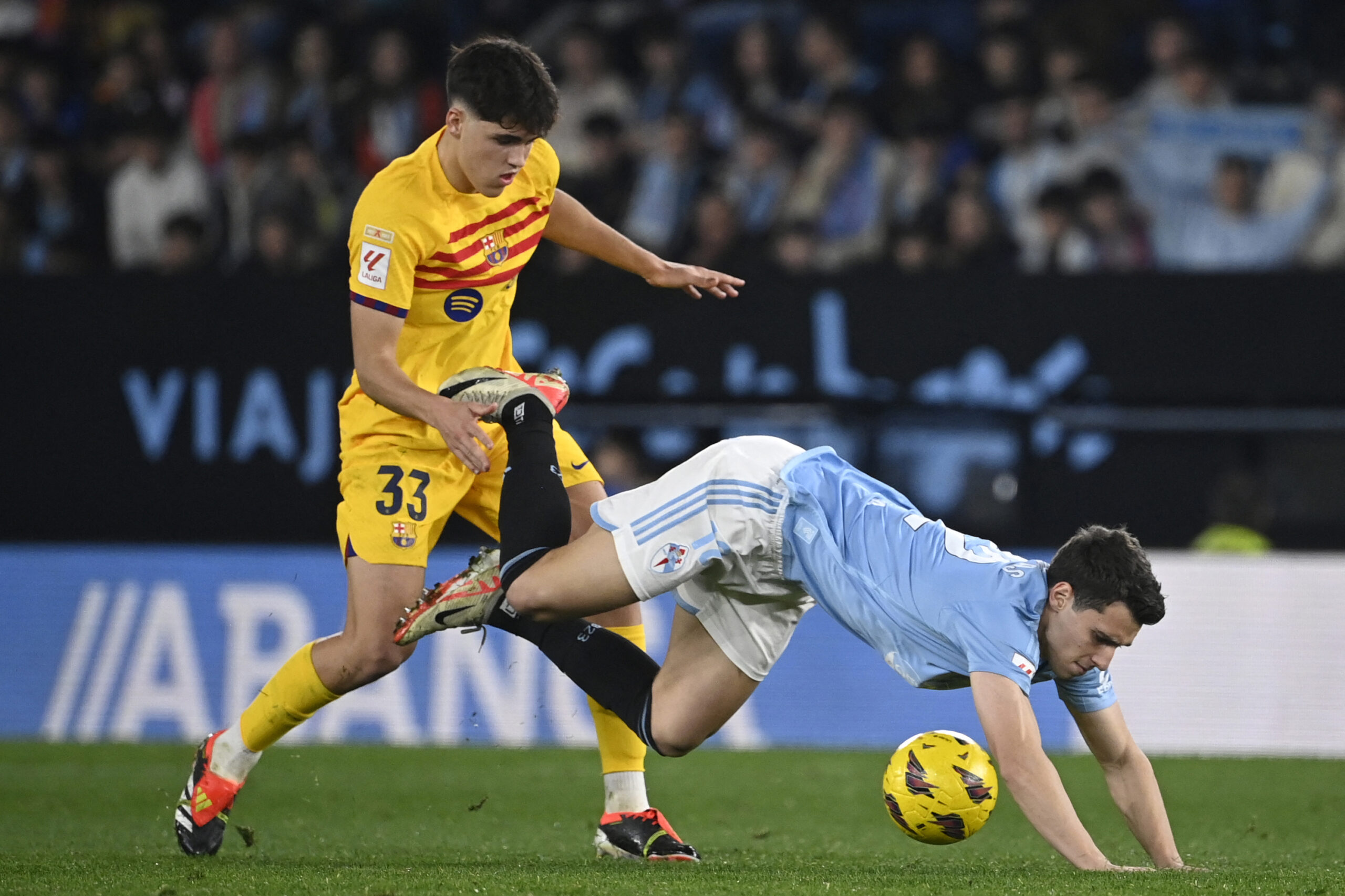 Barcelona's Spanish defender #33 Pau Cubarsi vies with Celta Vigo's Greek forward #12 Anastasios Douvikas during the Spanish league football match between RC Celta de Vigo and FC Barcelona at the Balaidos stadium in Vigo on February 17, 2024.