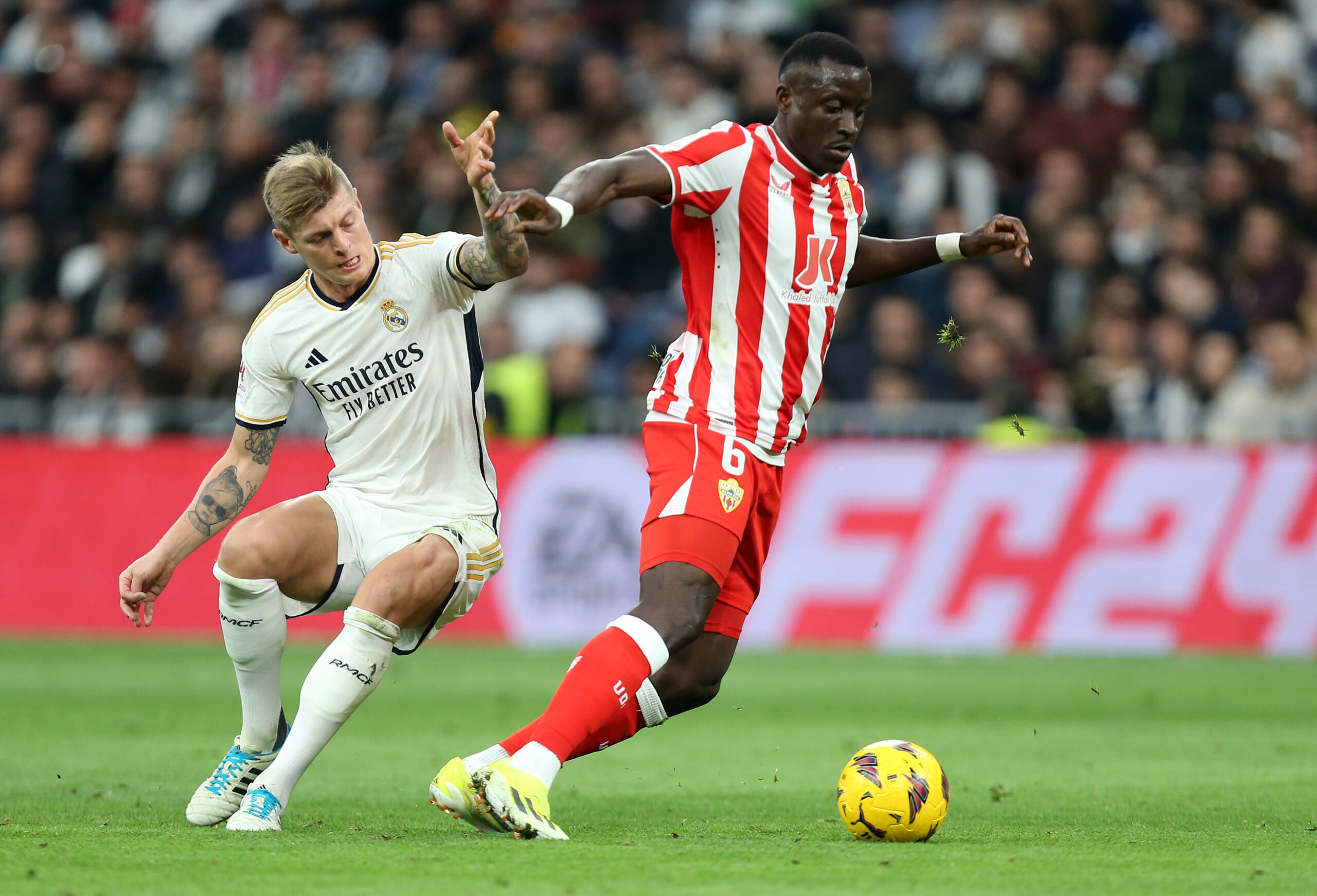 MADRID, SPAIN - JANUARY 21: Dion Lopy of UD Almeria is challenged by Toni Kroos of Real Madrid during the LaLiga EA Sports match between Real Madrid CF and UD Almeria at Estadio Santiago Bernabeu on January 21, 2024 in Madrid, Spain.