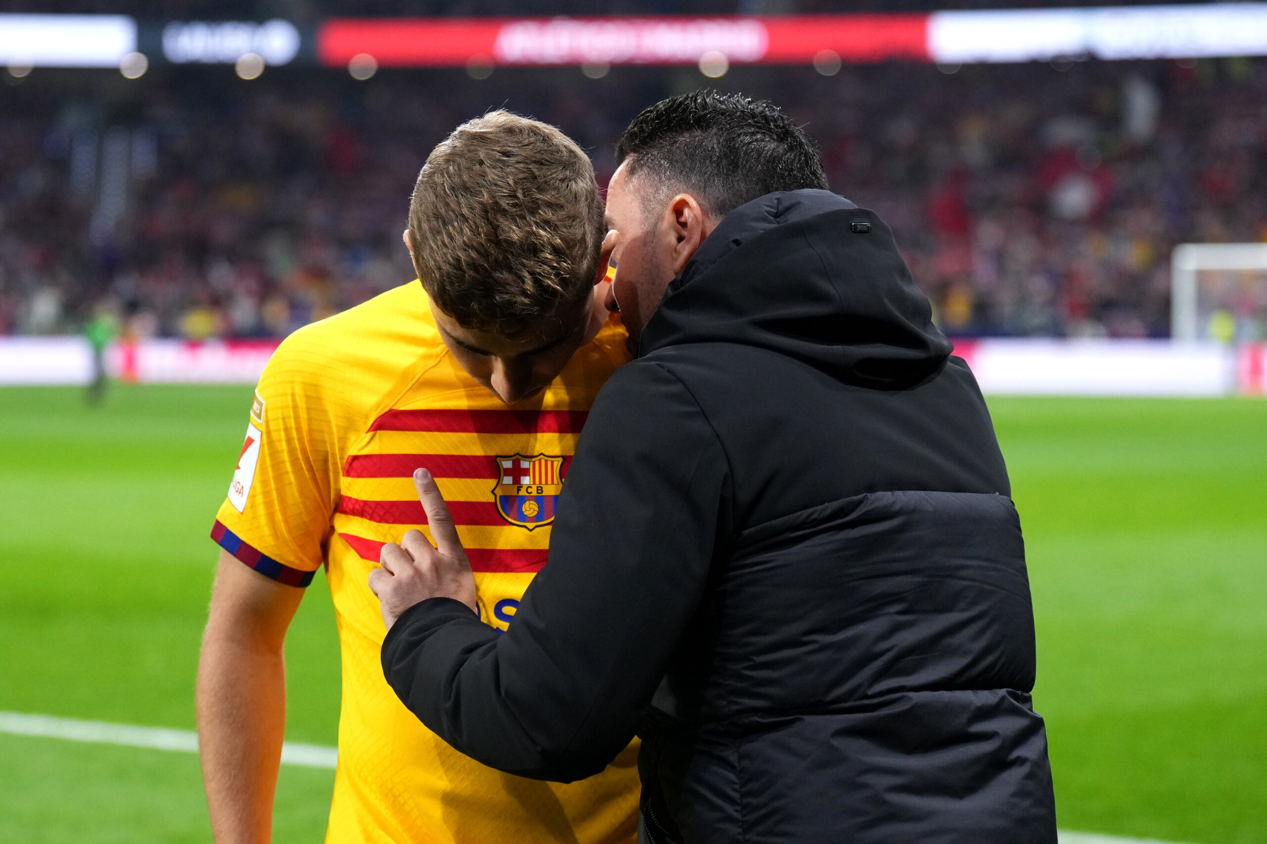 MADRID, SPAIN - MARCH 17: Xavi, Head Coach of FC Barcelona, talks with Fermin Lopez of FC Barcelona during the LaLiga EA Sports match between Atletico Madrid and FC Barcelona at Civitas Metropolitano Stadium on March 17, 2024 in Madrid, Spain.
