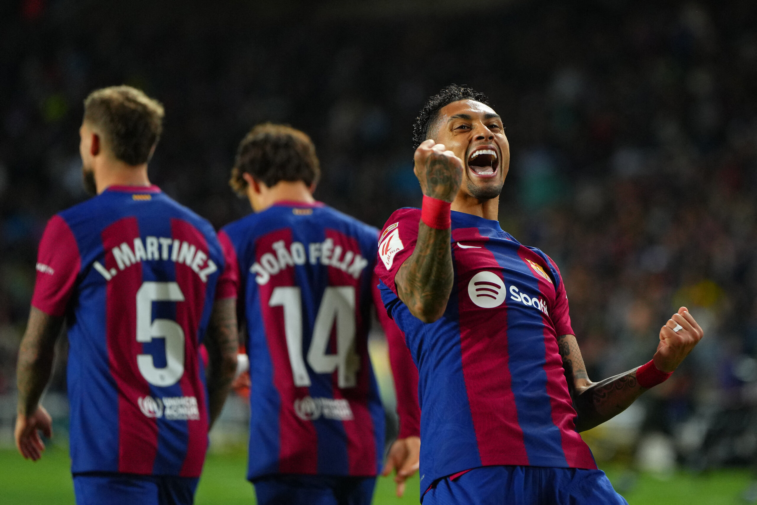 Barcelona's Brazilian forward #11 Raphinha celebrates after scoring his team's first goal during the Spanish league football match between FC Barcelona and UD Las Palmas at the Estadi Olimpic Lluis Companys in Barcelona on March 30, 2024.