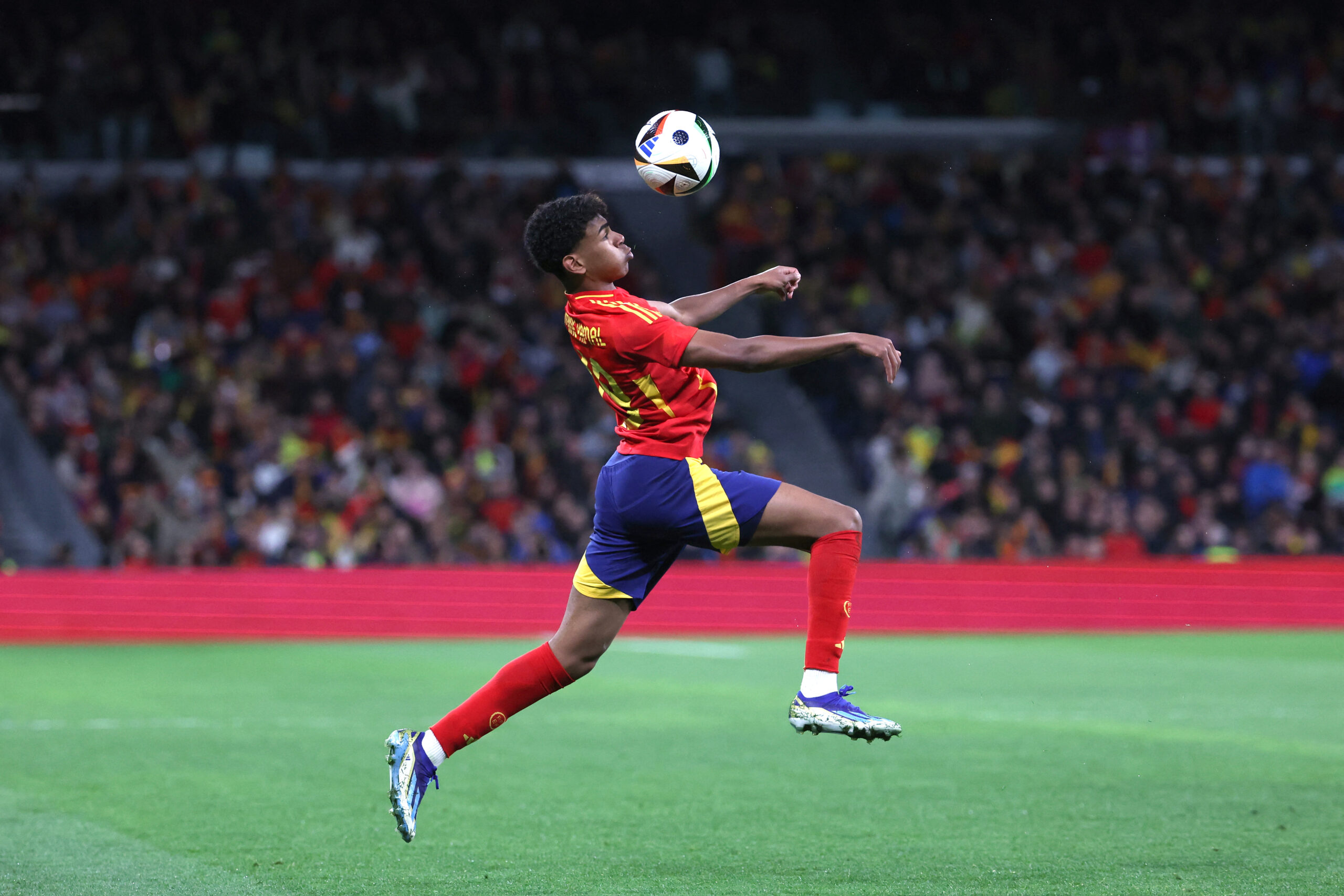 Spain's forward #19 Lamine Yamal controls the ball during the international friendly football match between Spain and Brazil at the Santiago Bernabeu stadium in Madrid, on March 26, 2024. Spain arranged a friendly against Brazil at the Santiago Bernabeu under the slogan 