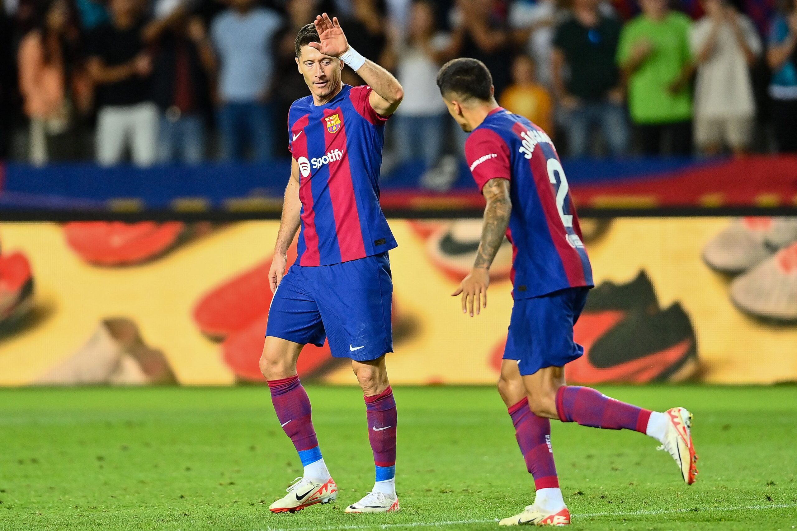 Barcelona's Portuguese defender #02 Joao Cancelo celebrates with Barcelona's Polish forward #09 Robert Lewandowski after scoring his team's third goal during the Spanish Liga football match between FC Barcelona and RC Celta de Vigo at the at the Estadi Olimpic Lluis Companys in Barcelona on September 23, 2023.