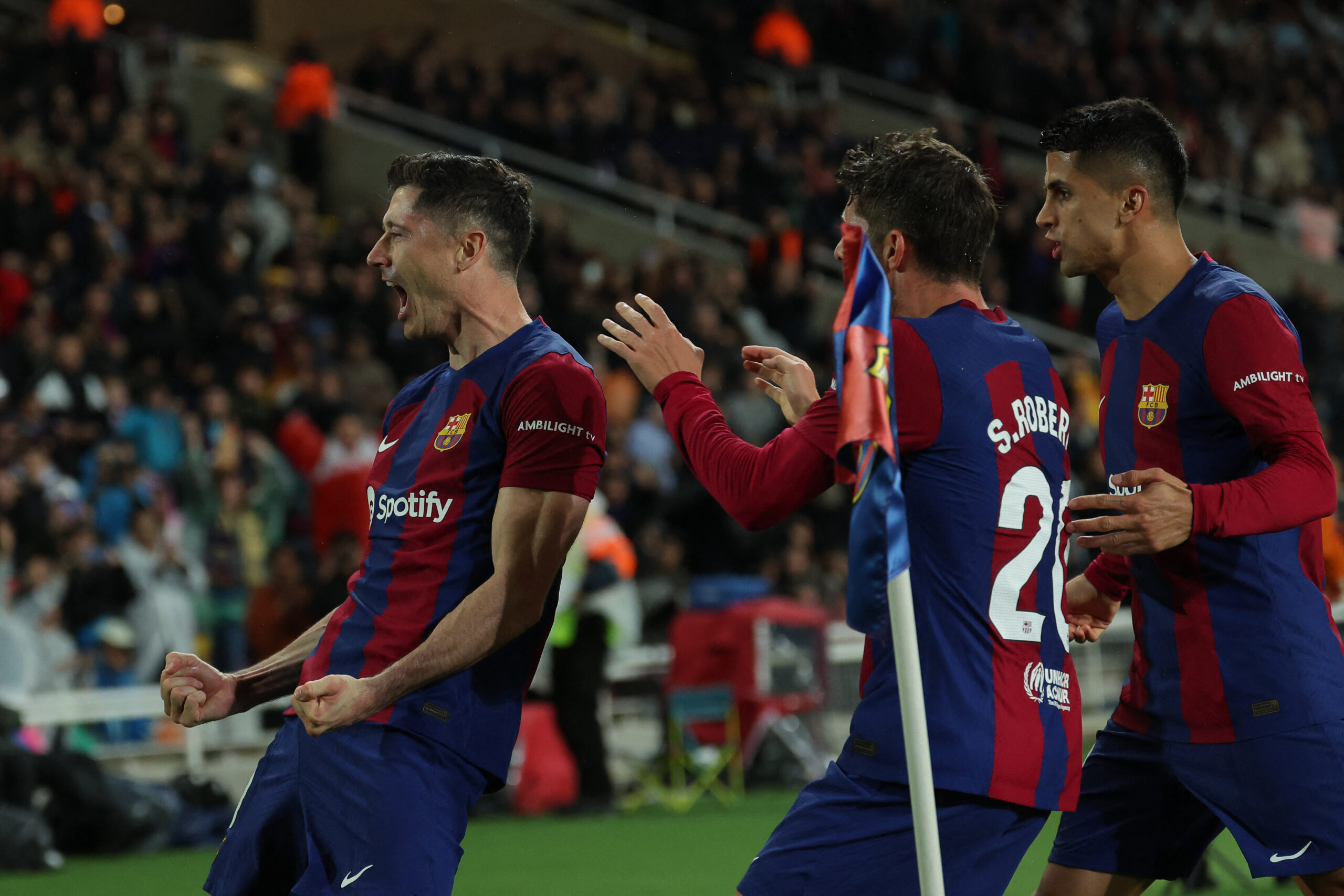 Barcelona's Polish forward #09 Robert Lewandowski celebrates with teammates after scoring his team's third goal during the Spanish league football match between FC Barcelona and Valencia CF at the Estadi Olimpic Lluis Companys in Barcelona on April 29, 2024.