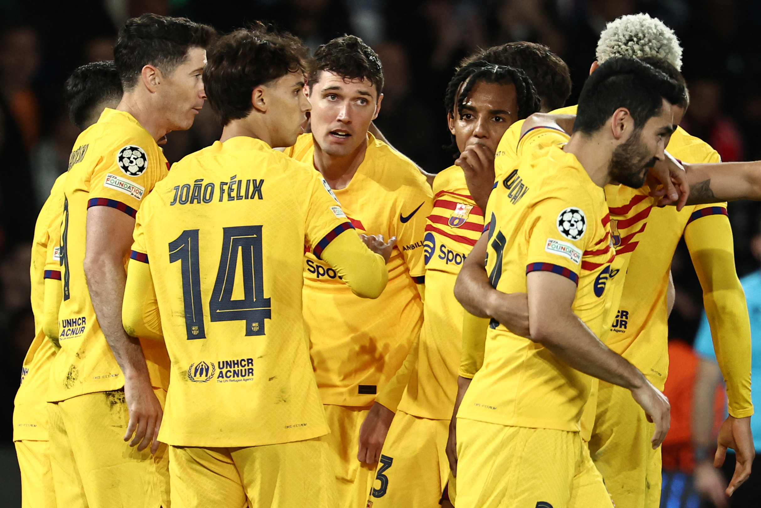 Barcelona's players congratulate Barcelona's Danish defender #15 Andreas Christensen (C) after scoring Barcelona's third goal during the UEFA Champions League quarter final first leg football match between Paris Saint-Germain (PSG) and FC Barcelona at the Parc des Princes stadium in Paris on April 10, 2024.