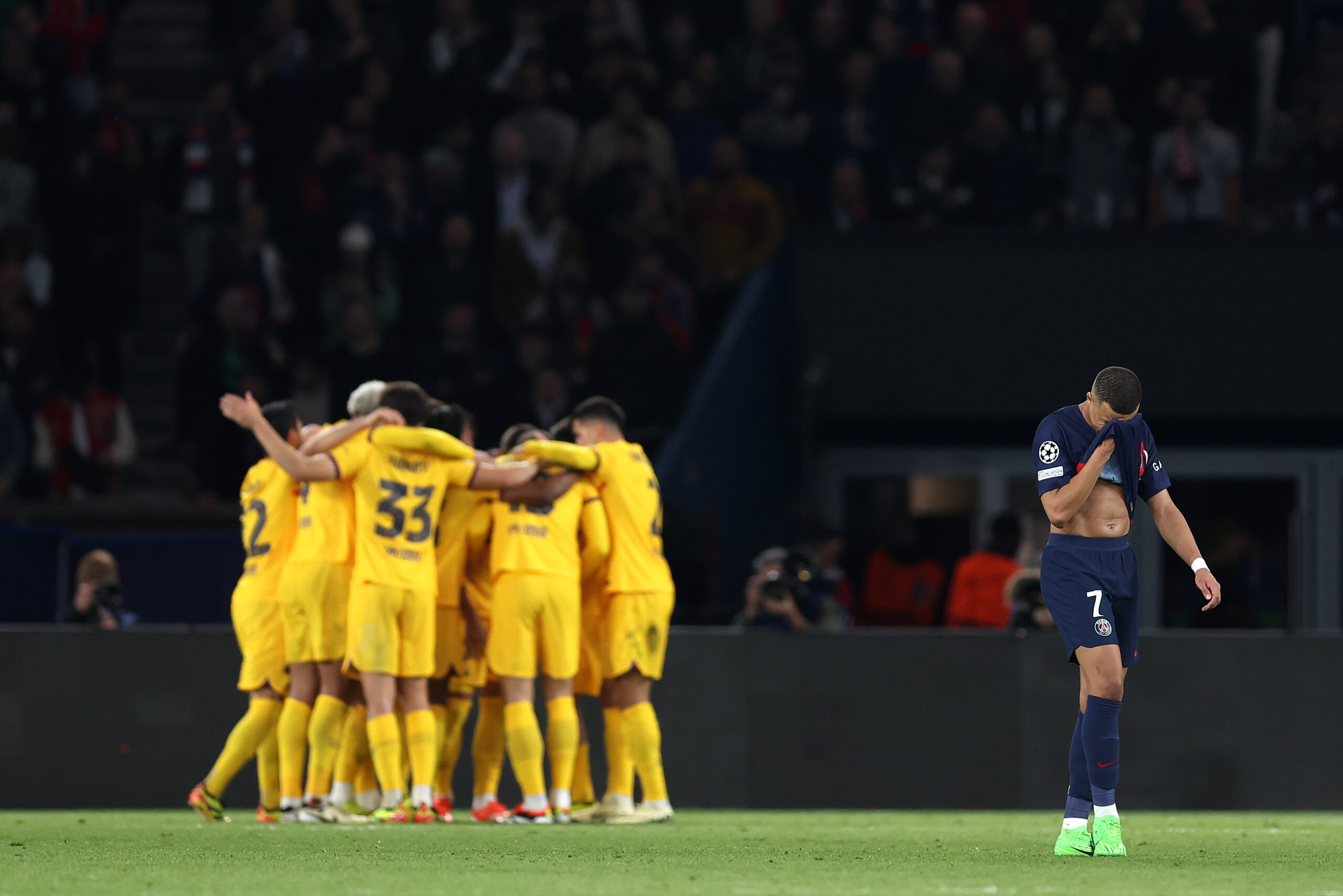 PARIS, FRANCE - APRIL 10: Kylian Mbappe of Paris Saint-Germain reacts as Andreas Christensen of FC Barcelona celebrates scoring his team's third goal during the UEFA Champions League quarter-final first leg match between Paris Saint-Germain and FC Barcelona at Parc des Princes on April 10, 2024 in Paris, France.