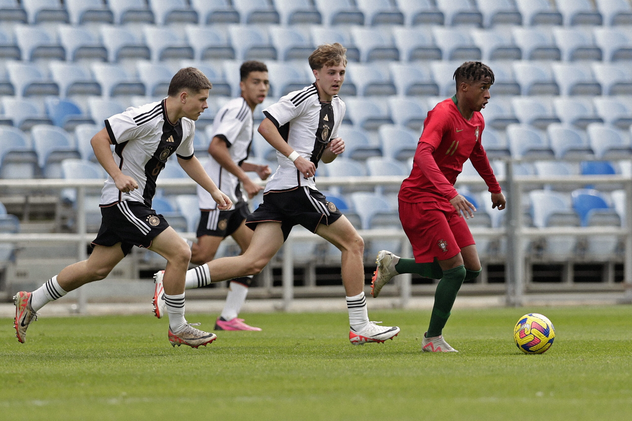 ALMANCIL, PORTUGAL - FEBRUARY 14: Nick Cherny (L) and Kacper Koscierski (C) of U17 Germany challenges Cardoso Varela (R) of U17 Portugal during the Portugal U17 v Germany U17 - Algarve Cup match on February 14, 2024 in Almancil, Portugal.