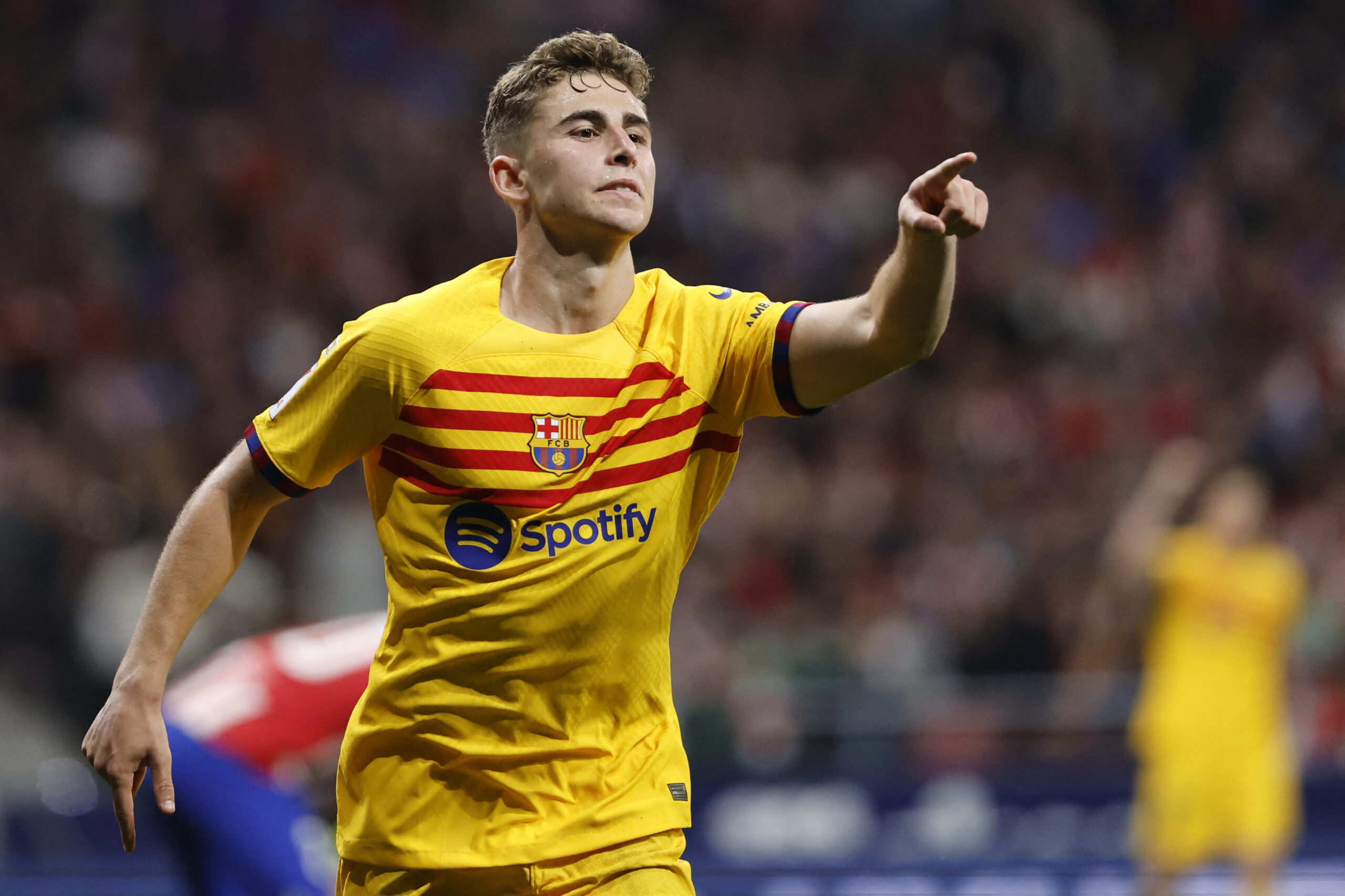 TOPSHOT - Barcelona's Spanish midfielder #32 Fermin Lopez celebrates scoring his team's third goal #09 Robert Lewandowski during the Spanish league football match between Club Atletico de Madrid and FC Barcelona at the Metropolitano stadium in Madrid on March 17, 2024.