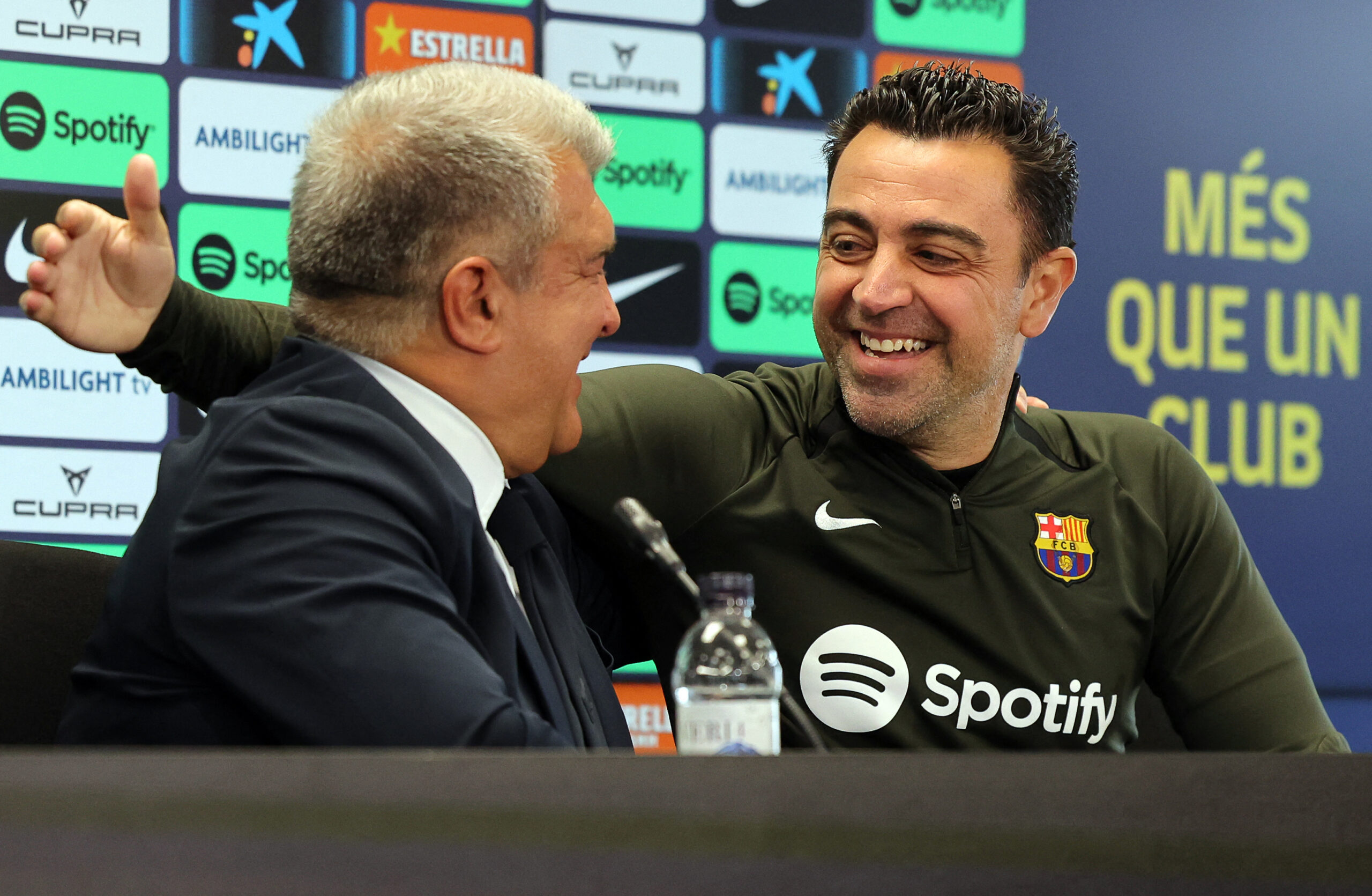 TOPSHOT - FC Barcelona President Joan Laporta (L) and Barcelona's Spanish coach Xavi react during a press conference at the Joan Gamper training ground in Sant Joan Despi, near Barcelona, on April 25, 2024. Xavi will remain as coach of Barcelona, the Spanish giants told AFP on April 24, despite having announced in January that he planned to quit at the end of the season due to the 