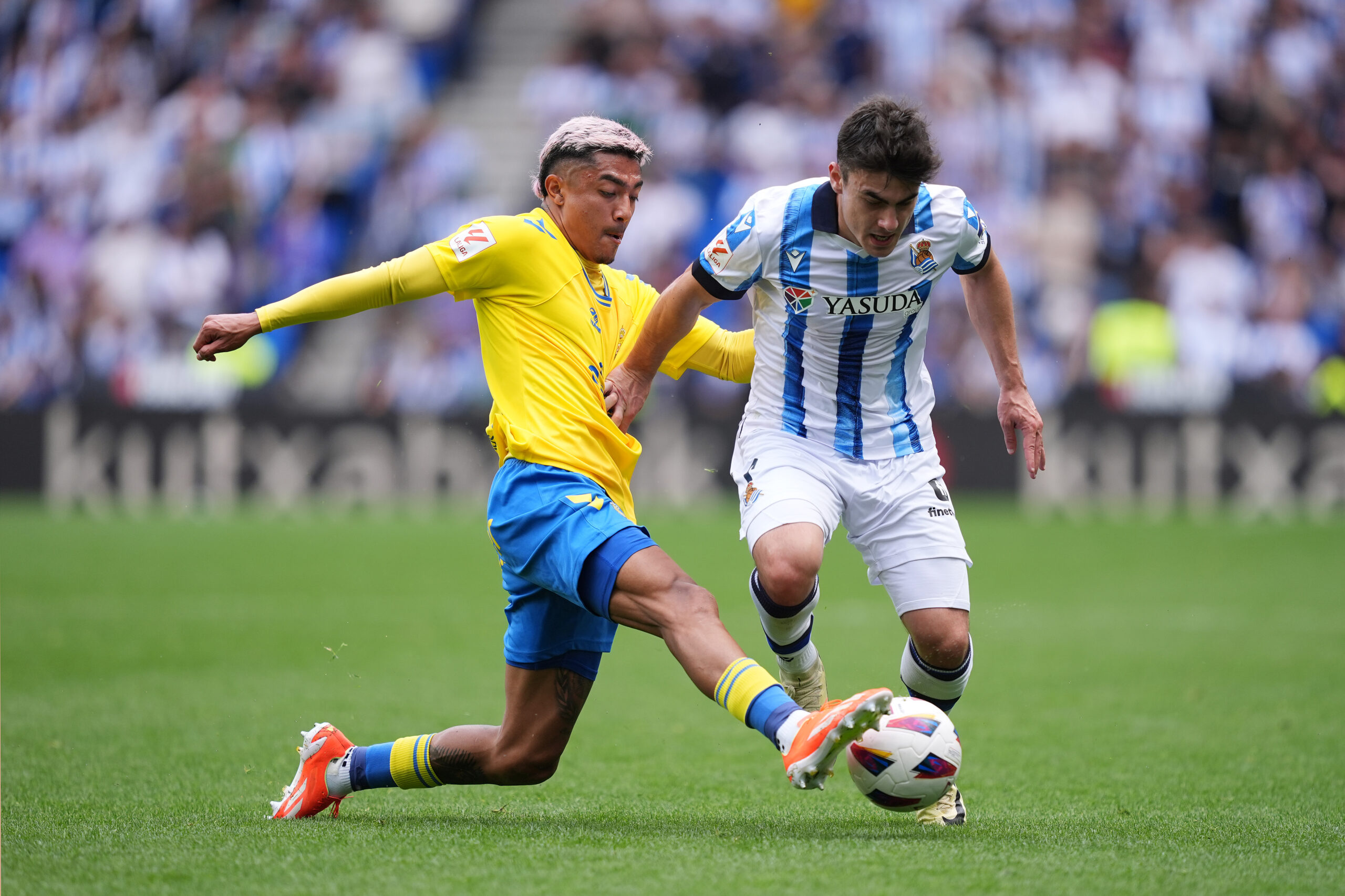 SAN SEBASTIAN, SPAIN - MAY 04: Julian Araujo ( Barcelona Loanee currently playing at UD Las Palmas ) challenges Ander Barrenetxea of Real Sociedad during the LaLiga EA Sports match between Real Sociedad and UD Las Palmas at Reale Arena on May 04, 2024 in San Sebastian, Spain.