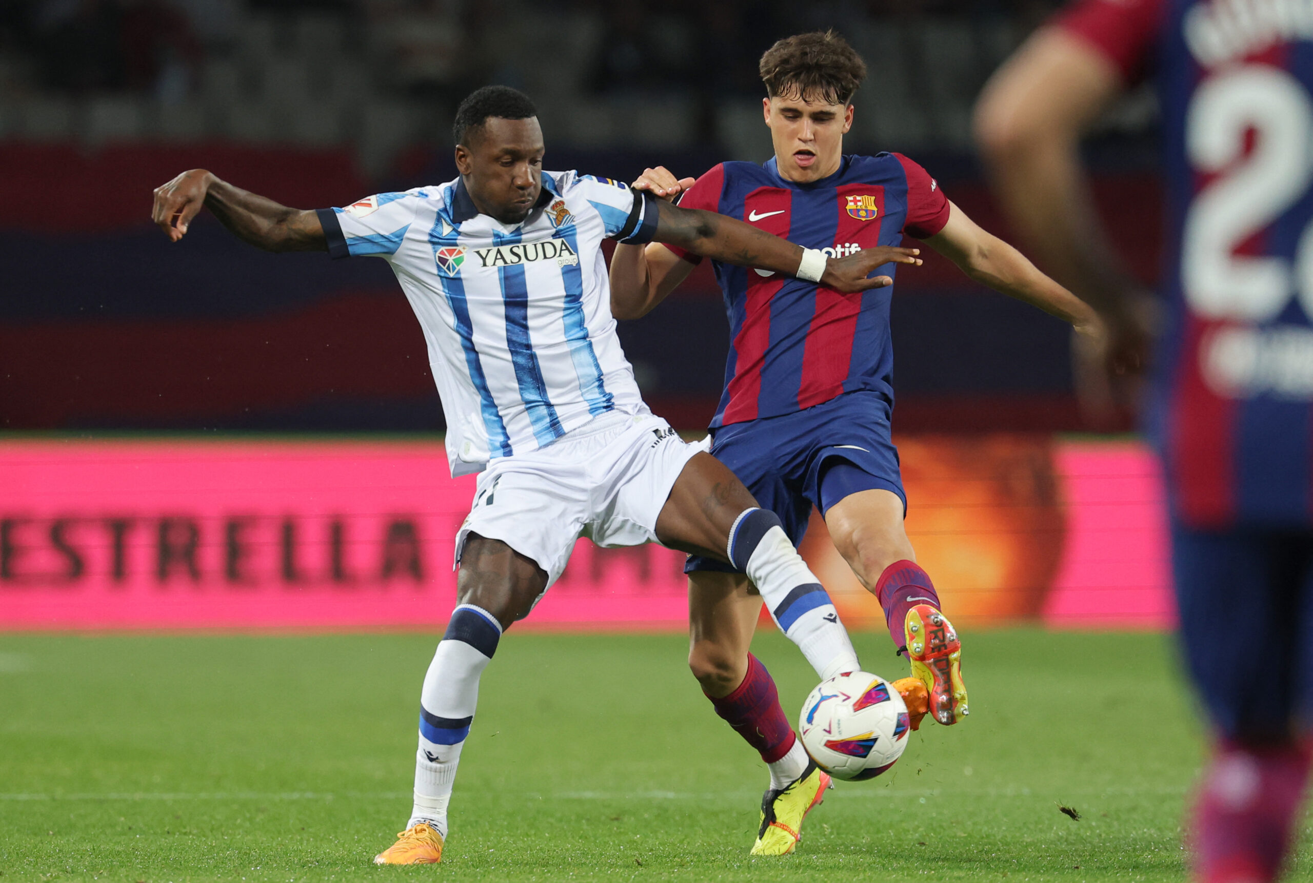 Real Sociedad's Dutch forward #11 Sheraldo Becker vies with Barcelona's Spanish defender #33 Pau Cubarsi during the Spanish league football match between FC Barcelona and Real Sociedad at the Estadi Olimpic Lluis Companys in Barcelona on May 13, 2024.