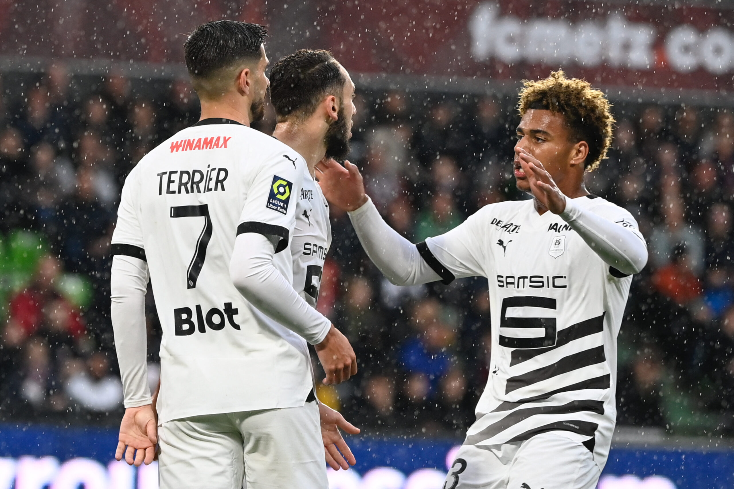 Rennes' Algerian forward #10 Amine Gouiri (C) celebrates with Rennes' French forward #07 Martin Terrier (L) and Rennes' French midfielder #33 Desire Doue after scoring his team's first goal during the French L1 football match between FC Metz and Stade Rennais FC at the Saint-Symphorien Stadium in Longeville-les-Metz, eastern France, on May 4, 2024.
