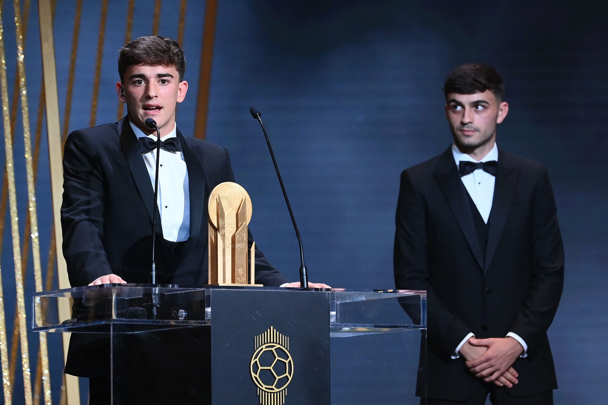 Barcelona's Spanish midfielder Gavi (L) poses with the Kopa Trophy for best under-21 player next to FC Barcelona's Spanish midfielder Pedri during the 2022 Ballon d'Or France Football award ceremony at the Theatre du Chatelet in Paris on October 17, 2022.