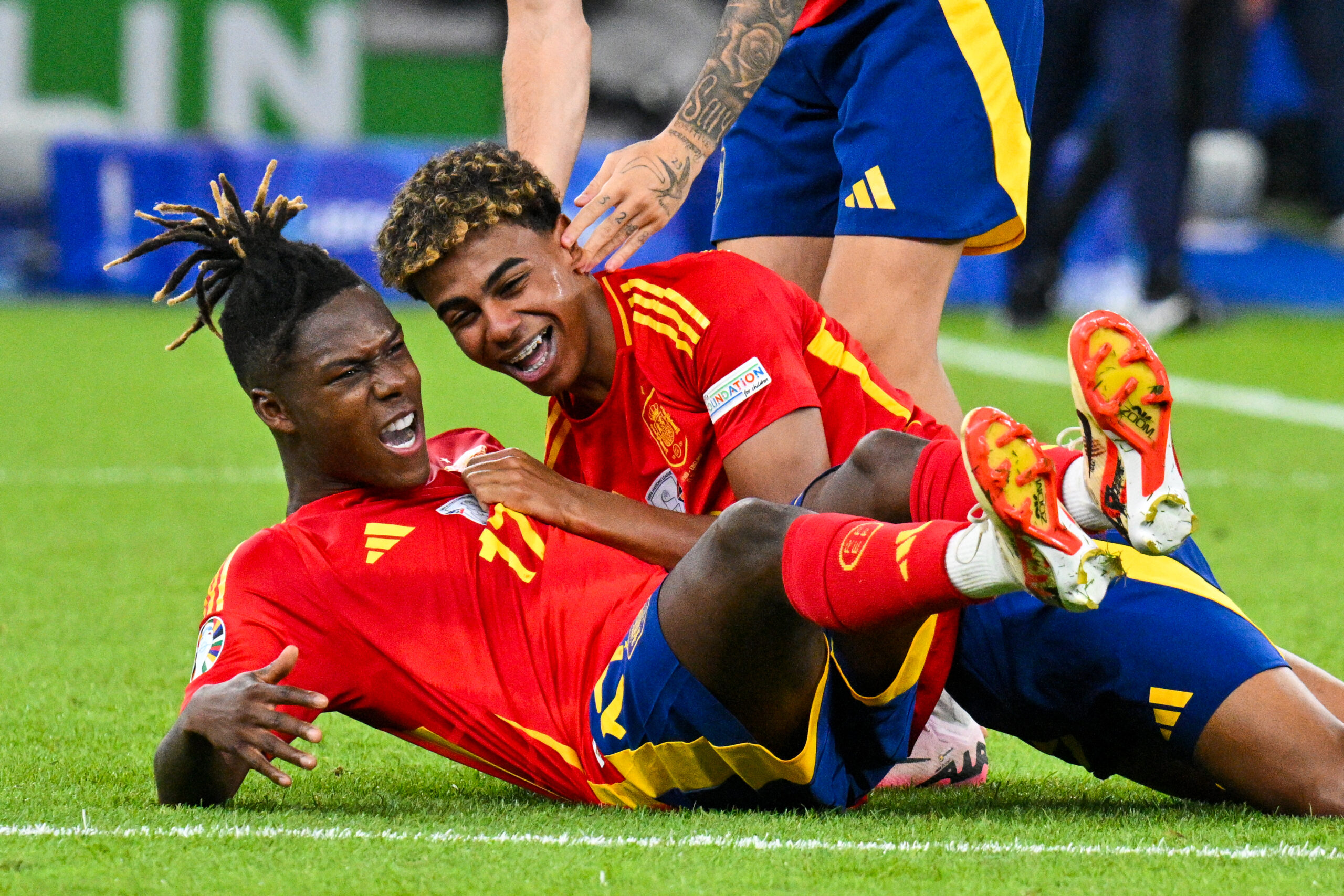 Spain's midfielder #17 Nico Williams (down) and Spain's forward #19 Lamine Yamal celebrate after winning the UEFA Euro 2024 final football match between Spain and England at the Olympiastadion in Berlin on July 14, 2024.