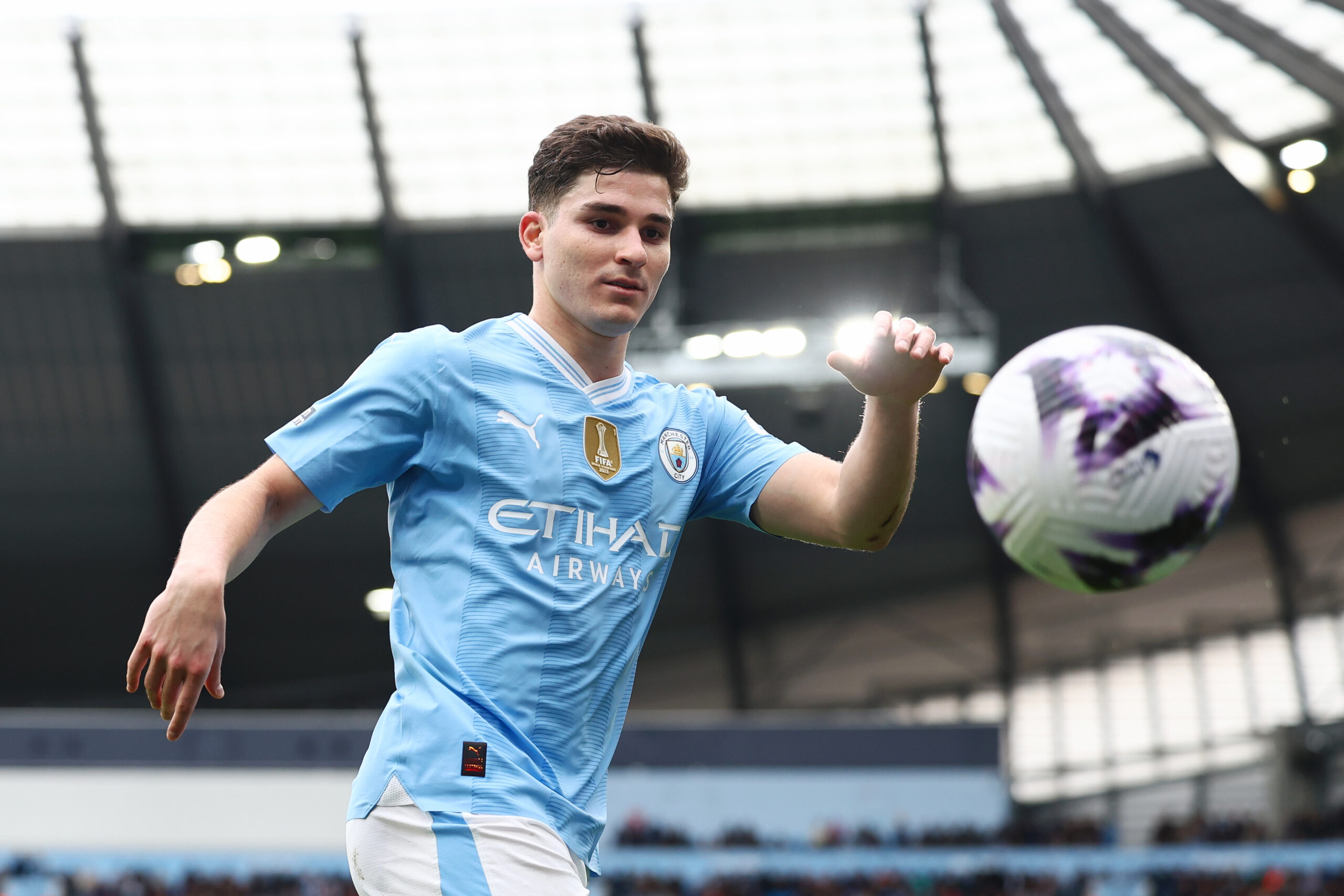MANCHESTER, ENGLAND - APRIL 13: Julian Alvarez of Manchester City catches the ball during the Premier League match between Manchester City and Luton Town at Etihad Stadium on April 13, 2024 in Manchester, England.