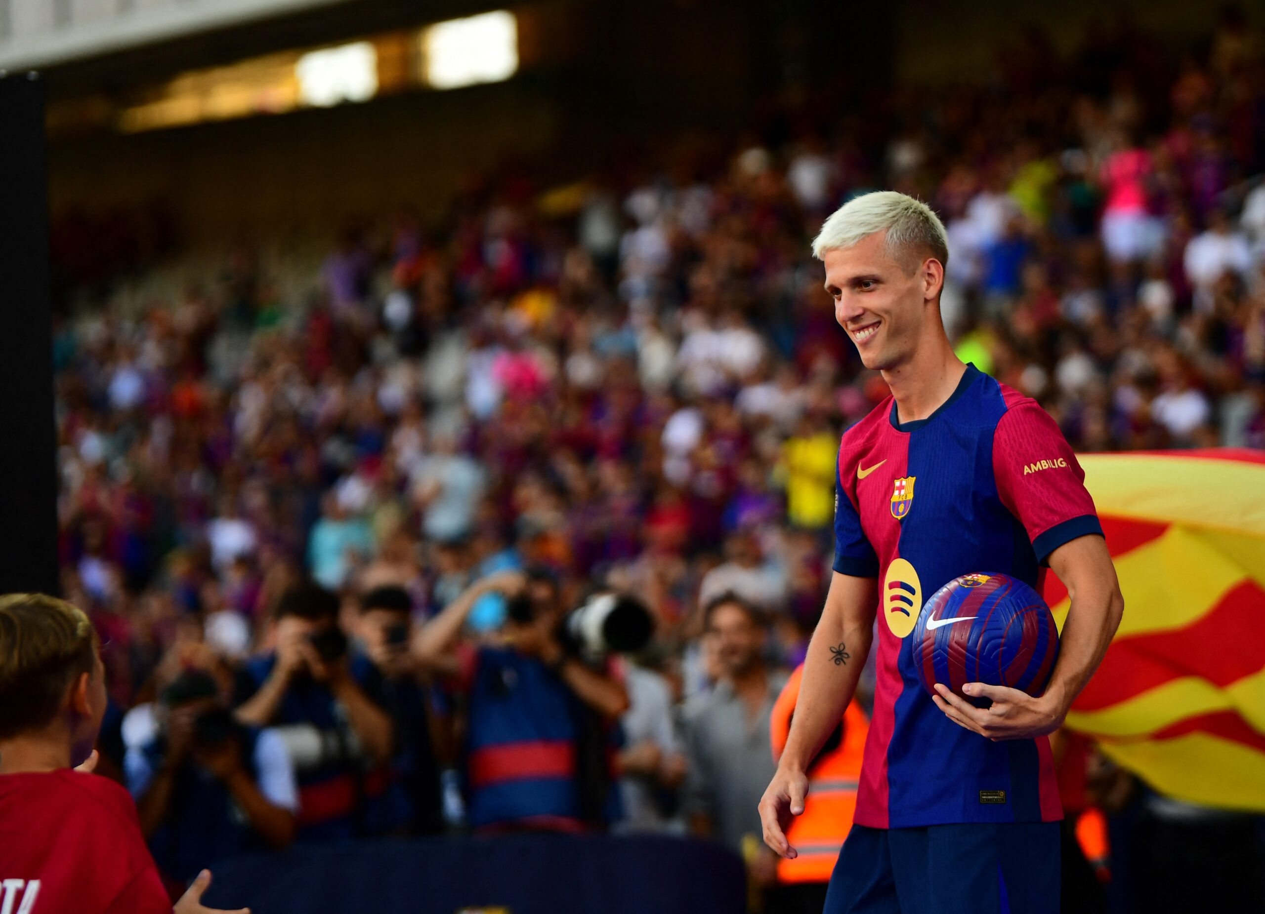 Barcelona's Spanish midfielder #20 Dani Olmo attends a presentation prior the 59th Joan Gamper Trophy football match between FC Barcelona and AS Monaco at the Estadi Olimpic Lluis Companys in Barcelona on August 12, 2024.