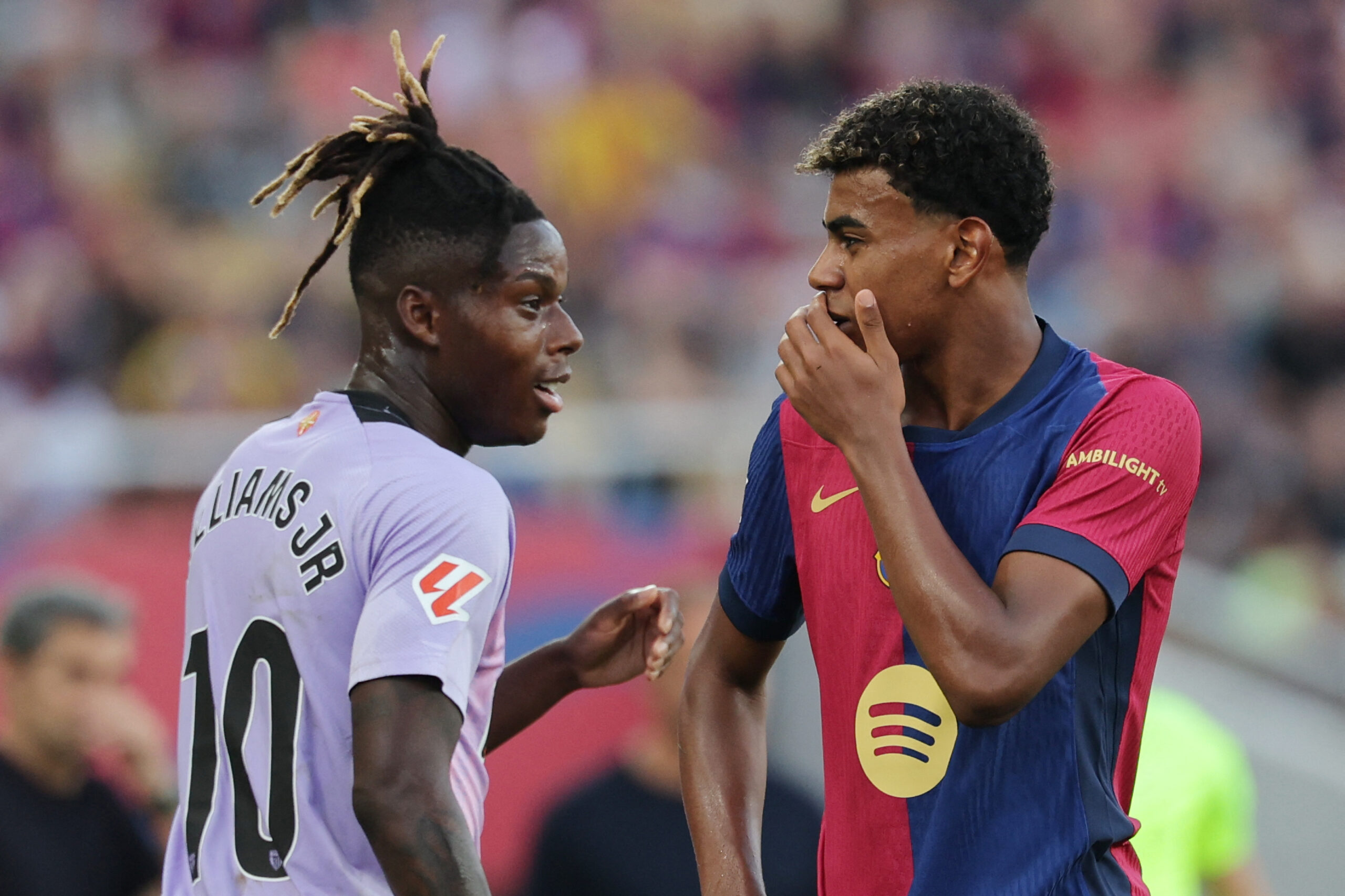 Athletic Bilbao's Spanish forward #10 Nico Williams (L) and Barcelona's Spanish forward #19 Lamine Yamal talk together during the Spanish league football match between FC Barcelona and Athletic Club Bilbao at the Estadi Olimpic Lluis Companys in Barcelona on August 24, 2024.