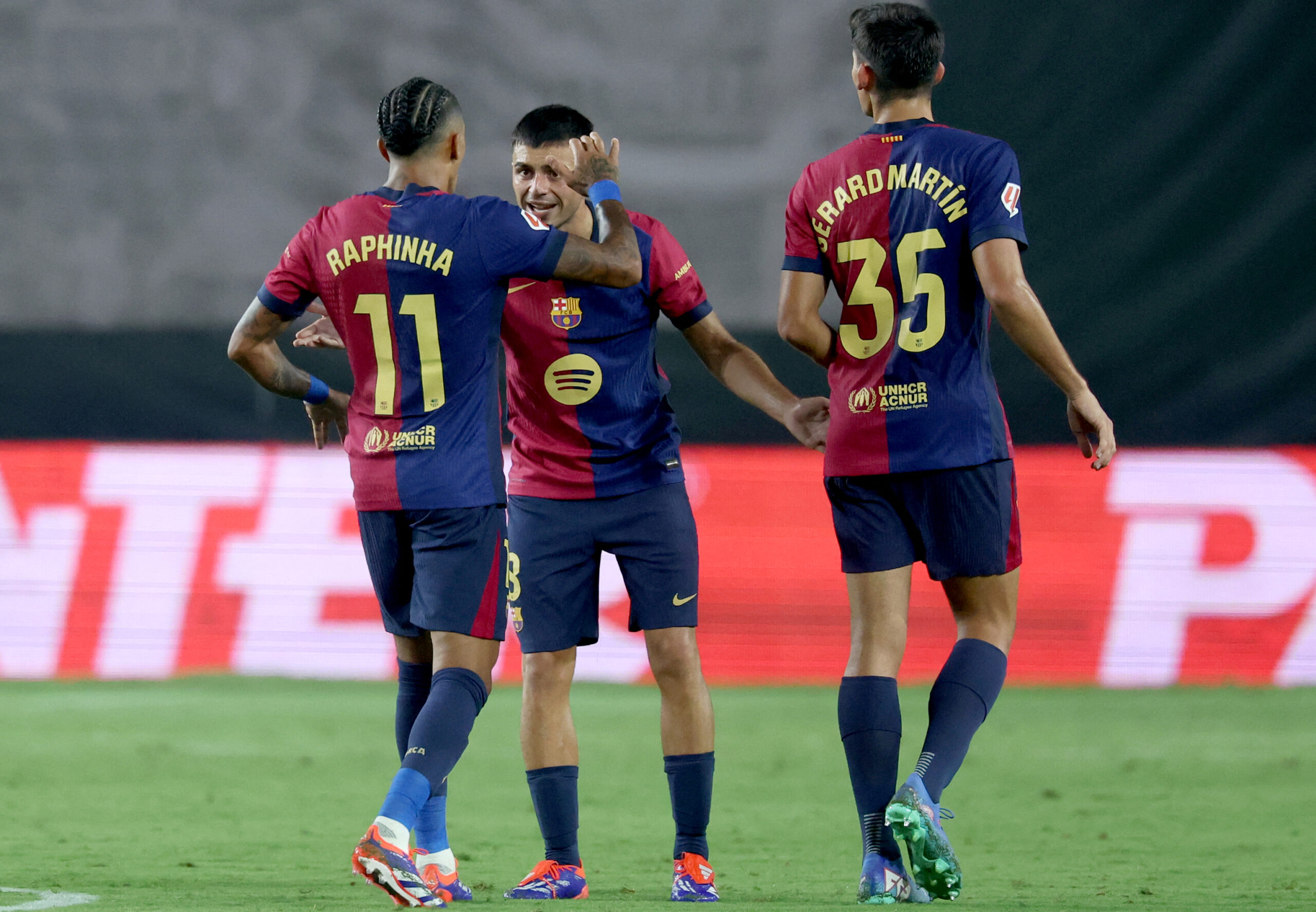 Barcelona's Spanish midfielder #08 Pedri celebrates with Barcelona's Brazilian forward #11 Raphinha scoring his team's first goal during the Spanish league football match between Rayo Vallecano de Madrid and FC Barcelona on August 27, 2024.