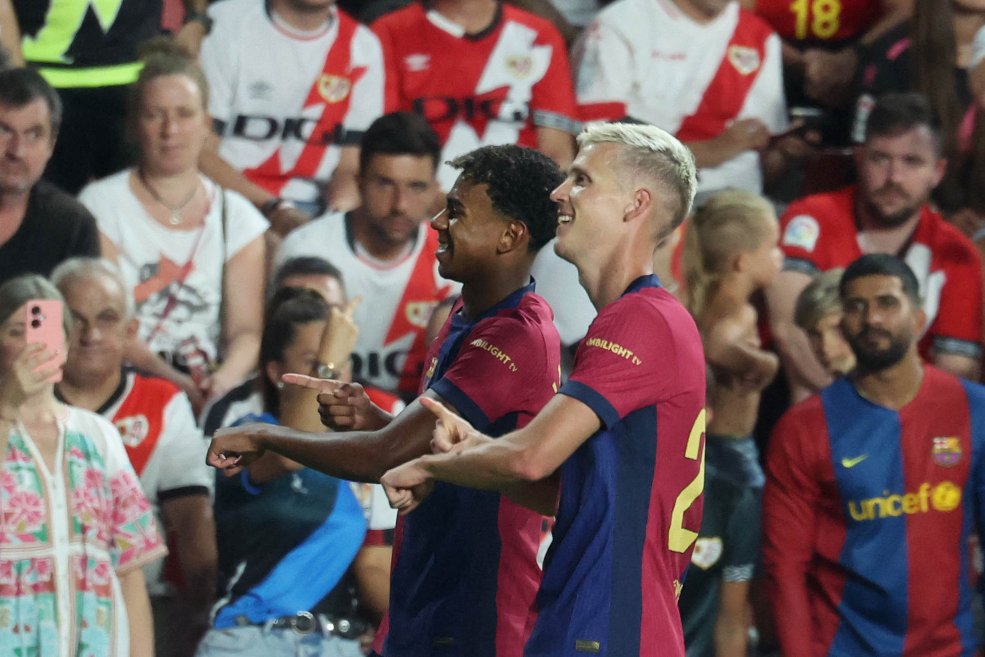 Barcelona's Spanish midfielder #20 Dani Olmo (R) celebrates with Barcelona's Spanish forward #19 Lamine Yamal scoring his team's second goal during the Spanish league football match between Rayo Vallecano de Madrid and FC Barcelona on August 27, 2024.