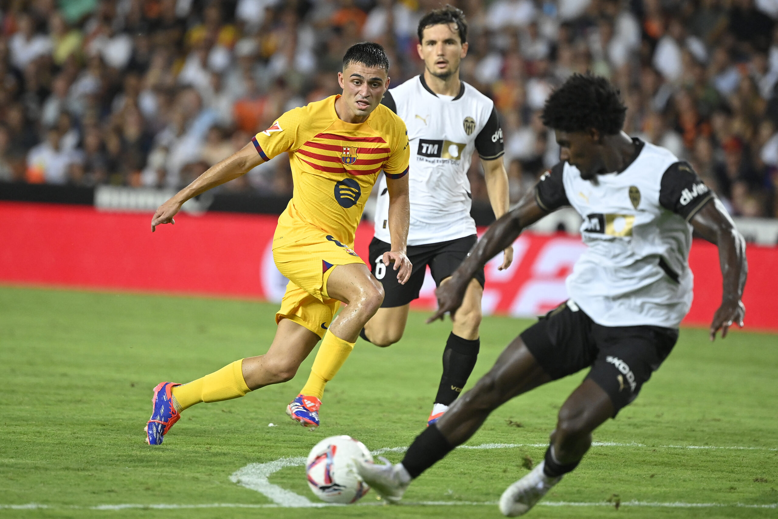 Barcelona's Spanish midfielder #08 Pedri (L) challenges Valencia's Portuguese defender #12 Thierry Correia during the Spanish league football match between Valencia CF and Barcelona at the Mestalla stadium in Valencia on August 17, 2024.