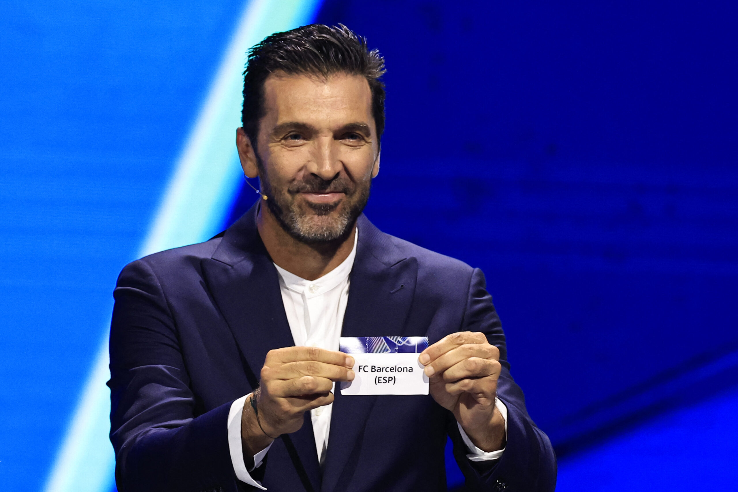 Italy's former goalkeeper Gianluigi Buffon shows the paper slip of Barcelona (ESP) during the group stage of the 2024-2025 UEFA Champions League football tournament, at the Grimaldi Forum in Monaco on August 29, 2024.