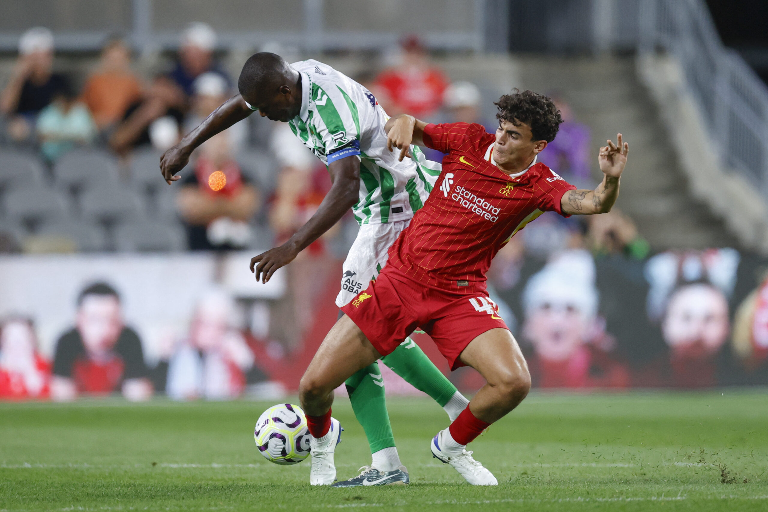 Real Betis' midfielder #14 William Carvalho (L) fights for the ball with Liverpool's midfielder #43 Stefan Bajcetic (R) during a pre-season club friendly football match between Liverpool and Real Betis at Acrisure Stadium, in Pittsburgh, Pennsylvania, on July 26, 2024.