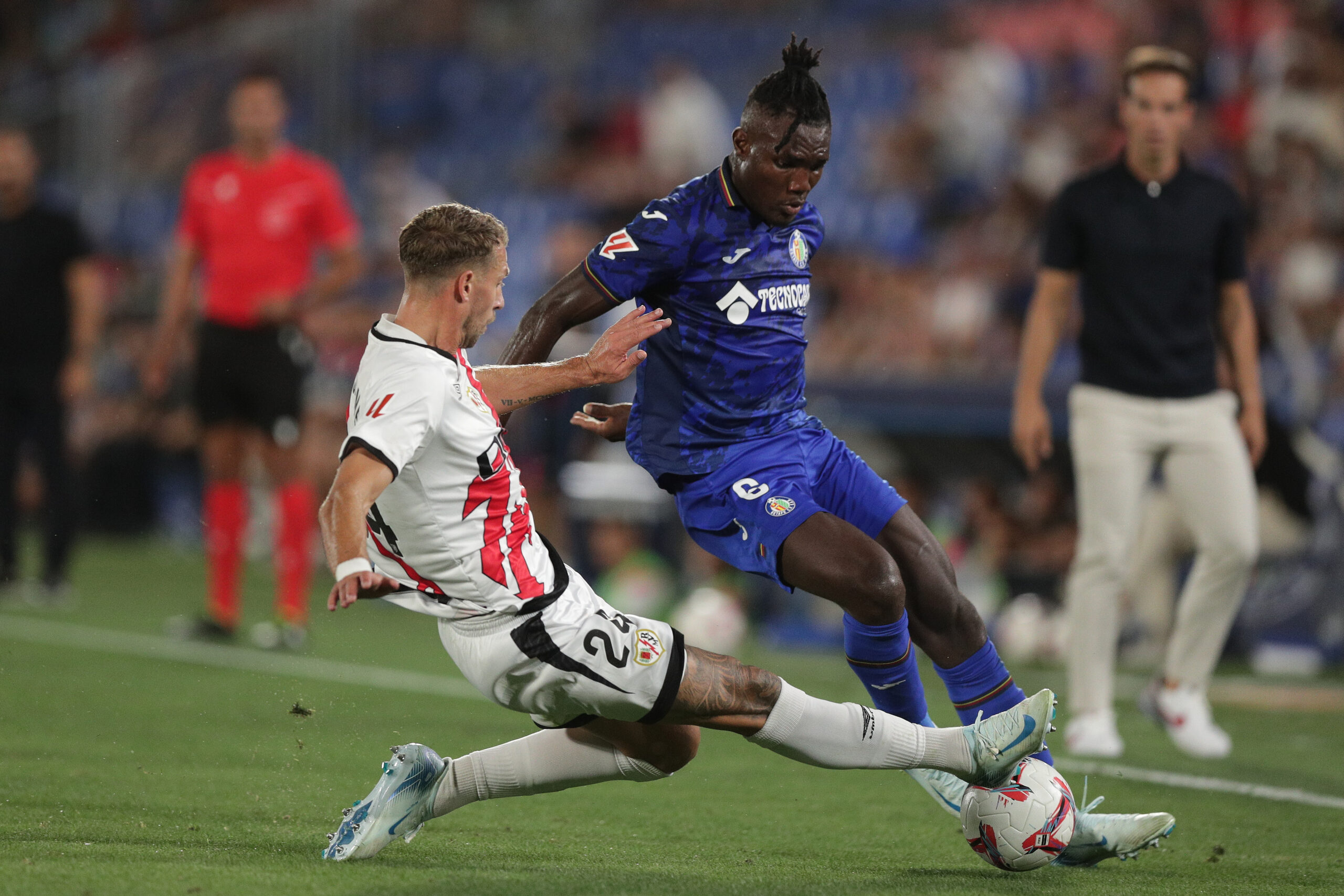 GETAFE, SPAIN - AUGUST 24: Christantus Ugonna Uche (L) of Getafe CF competes for the ball with Florian Lejeune (L) of Rayo Vallecano de Madrid during the La Liga match between Getafe CF and Rayo Vallecano de Madrid at Coliseum on August 24, 2024 in Getafe, Spain.