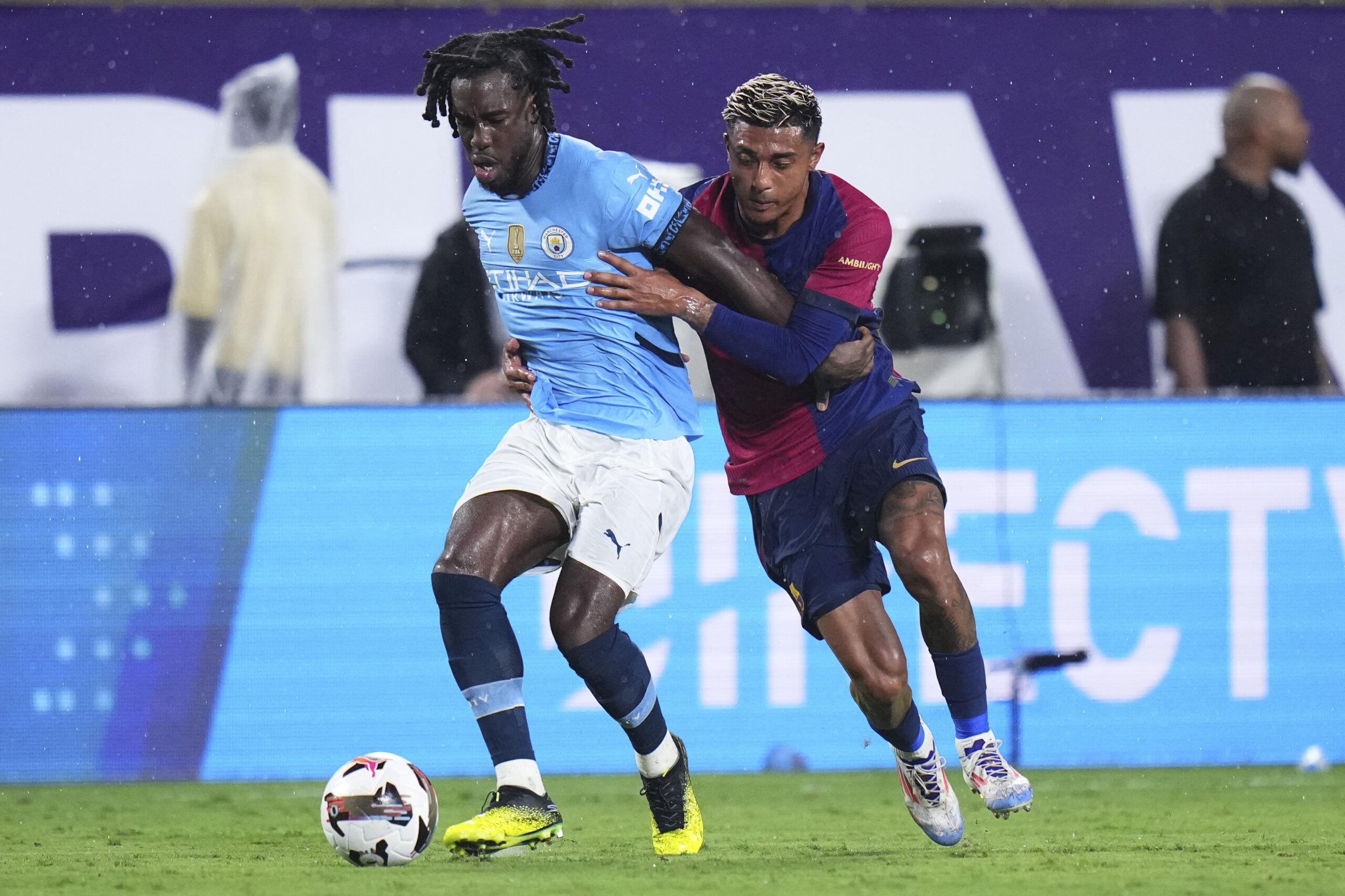ORLANDO, FLORIDA - JULY 30: Josh Wilson-Esbrand #97 of Manchester City dribbles the ball against Julián Araujo #2 of FC Barcelona in the second half during a pre-season match between Manchester City and FC Barcelona at Camping World Stadium on July 30, 2024 in Orlando, Florida.