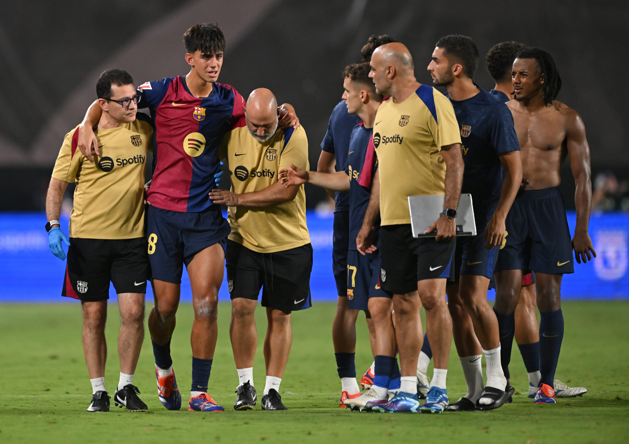 MADRID, SPAIN - AUGUST 27: Marc Bernal of FC Barcelona is helped from the pitch after getting injured during the La Liga match between Rayo Vallecano and FC Barcelona at Estadio de Vallecas on August 27, 2024 in Madrid, Spain.