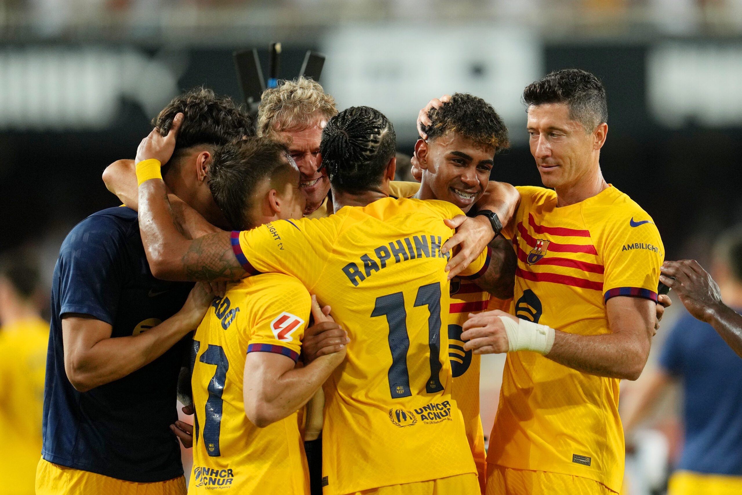 VALENCIA, SPAIN - AUGUST 17: Lamine Yamal of FC Barcelona celebrates victory with teammates Raphinha and Robert Lewandowski after the La Liga match between Valencia CF and FC Barcelona at Estadio Mestalla on August 17, 2024 in Valencia, Spain.