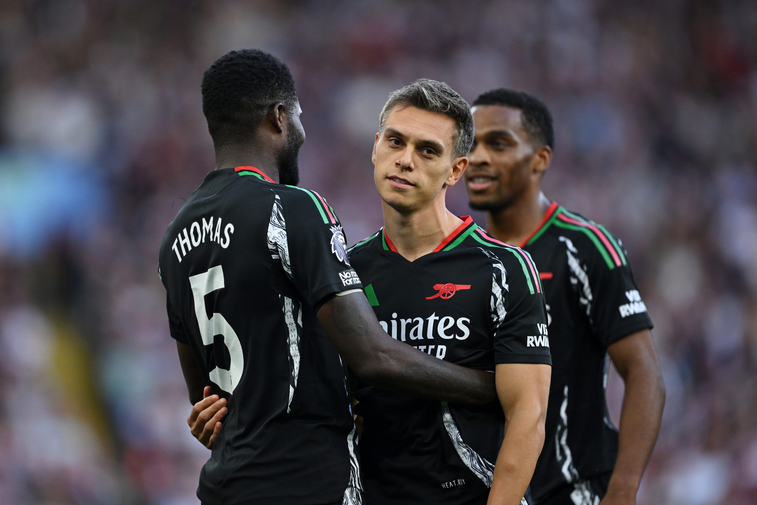 BIRMINGHAM, ENGLAND - AUGUST 24: Leandro Trossard of Arsenal celebrates scoring his team's first goal with teammate Thomas Partey during the Premier League match between Aston Villa FC and Arsenal FC at Villa Park on August 24, 2024 in Birmingham, England.