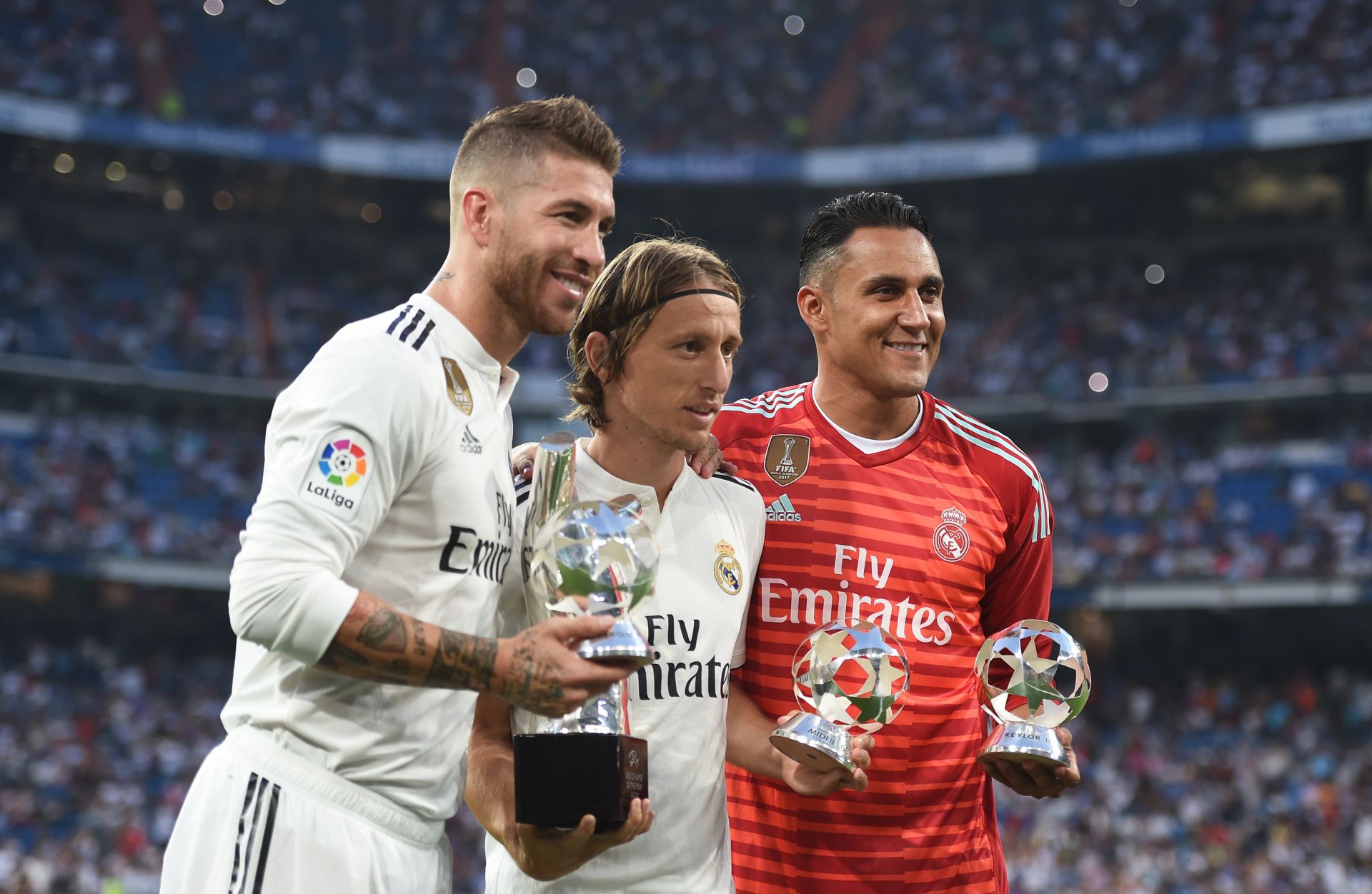 MADRID, SPAIN - SEPTEMBER 01: Sergio Ramos (left) Luka Modric (centre) and Keylor Navas of Real Madrid celebrate their 2017/18 UEFA Men's Defender, Player of the Year and Goalkeeper of the year awards respectively before the La Liga match between Real Madrid CF and CD Leganes at Estadio Santiago Bernabeu on September 1, 2018 in Madrid, Spain.