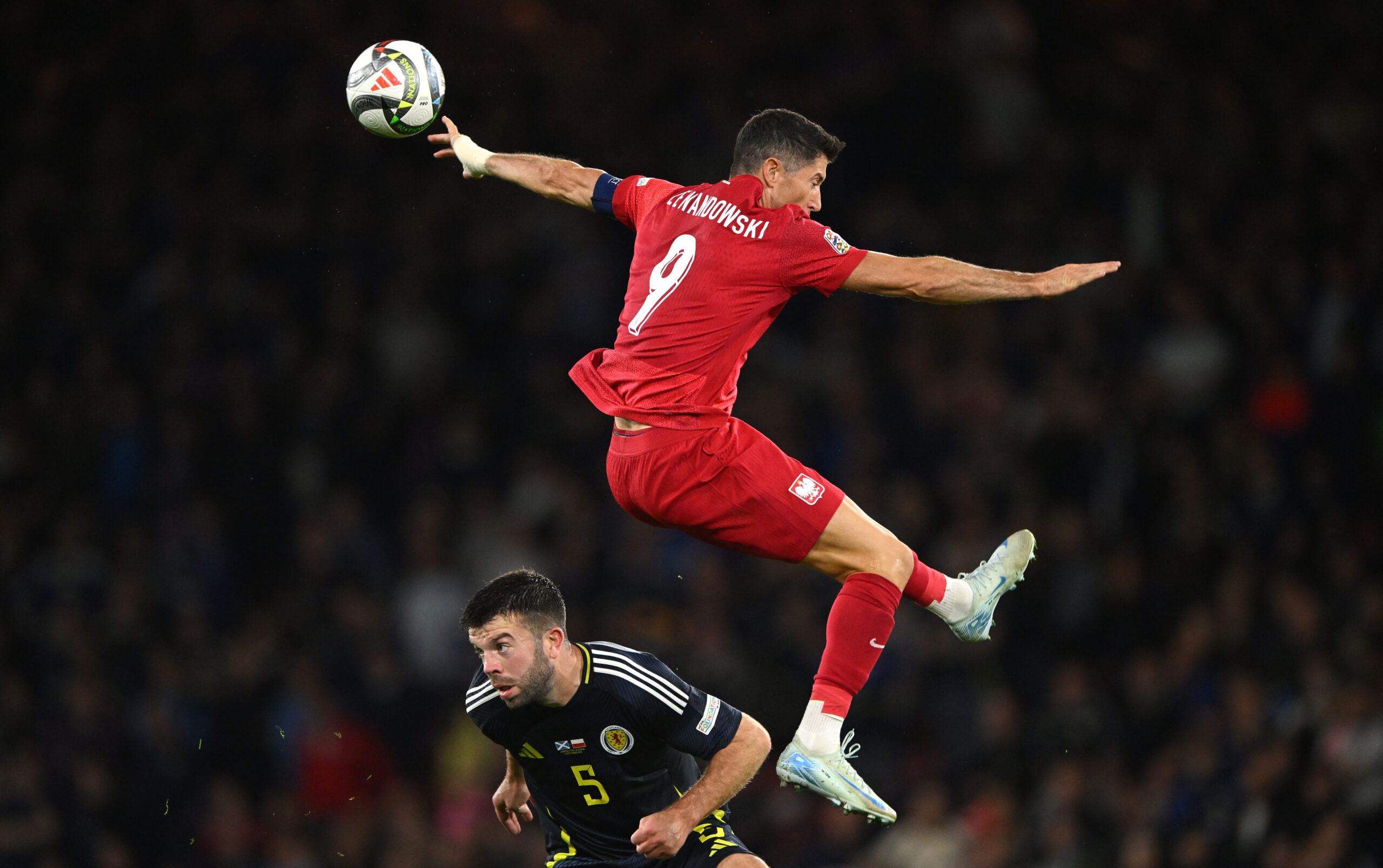 GLASGOW, SCOTLAND - SEPTEMBER 05: Robert Lewandowski of Poland is challenged by Grant Hanley of Scotland during the UEFA Nations League 2024/25 League A Group A1 match between Scotland and Poland at on September 05, 2024 in Glasgow, Scotland.