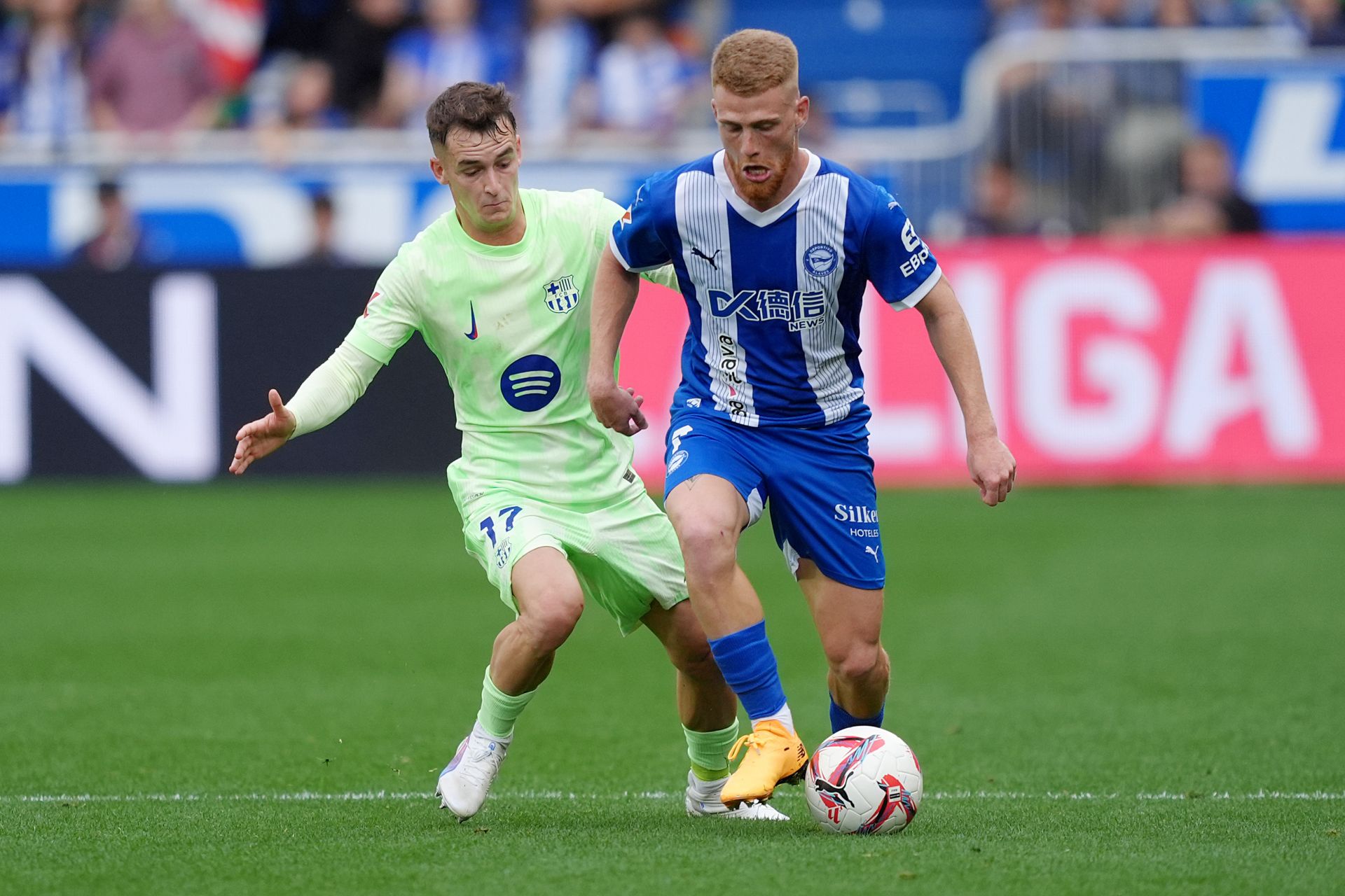 VITORIA-GASTEIZ, SPAIN - OCTOBER 06: Carlos Vicente of Alaves is challenged by Marc Casado of FC Barcelona during the LaLiga match between Deportivo Alaves and FC Barcelona at Estadio de Mendizorroza on October 06, 2024 in Vitoria-Gasteiz, Spain.