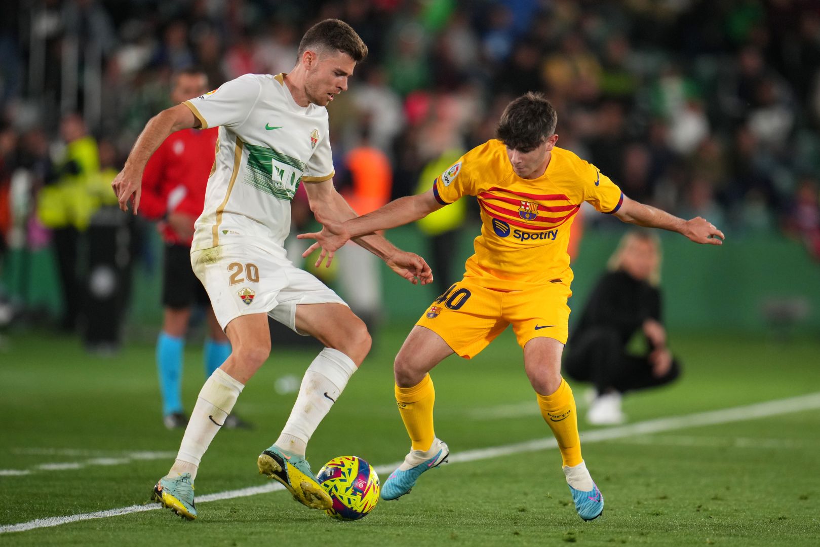 ELCHE, SPAIN - APRIL 01: Gerard Gumbau of Elche CF battles for possession with Aleix Garrido Canizares of FC Barcelona during the LaLiga Santander match between Elche CF and FC Barcelona at Estadio Manuel Martinez Valero on April 01, 2023 in Elche, Spain.