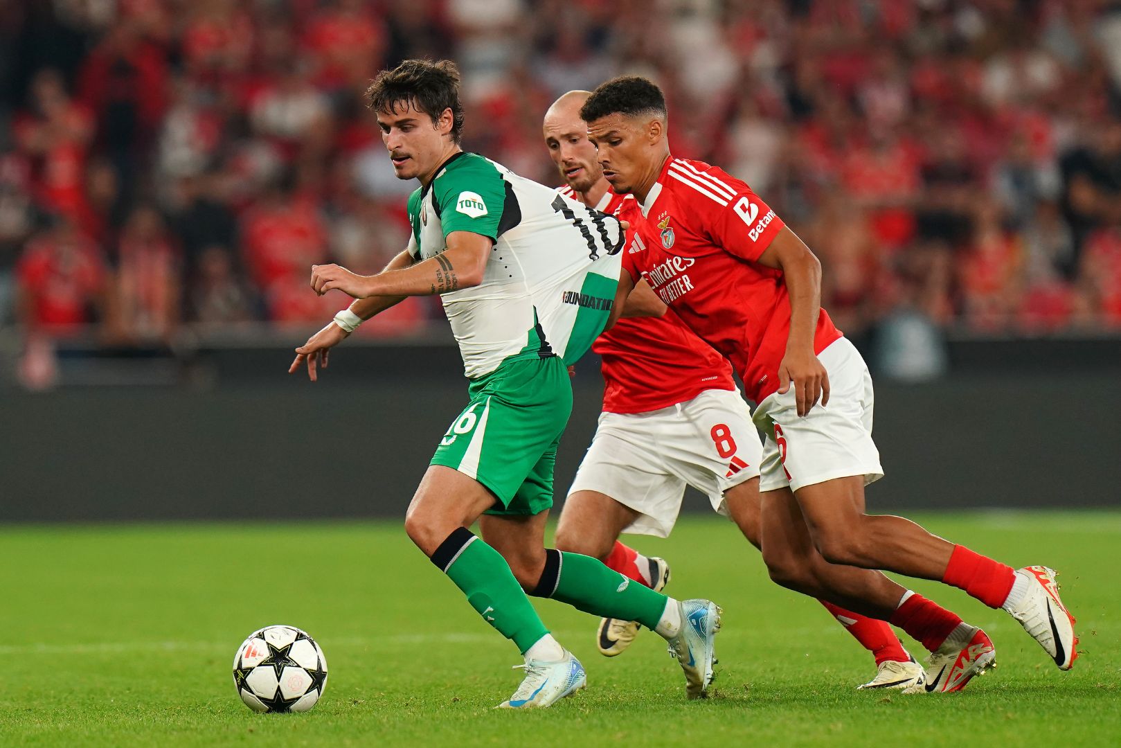 LISBON, PORTUGAL - OCTOBER 23: Hugo Bueno of Feyenoord is challenged by Alexander Bah of S.L Benfica during the UEFA Champions League 2024/25 League Phase MD3 match between SL Benfica and Feyenoord at Estadio do SL Benfica on October 23, 2024 in Lisbon, Portugal.