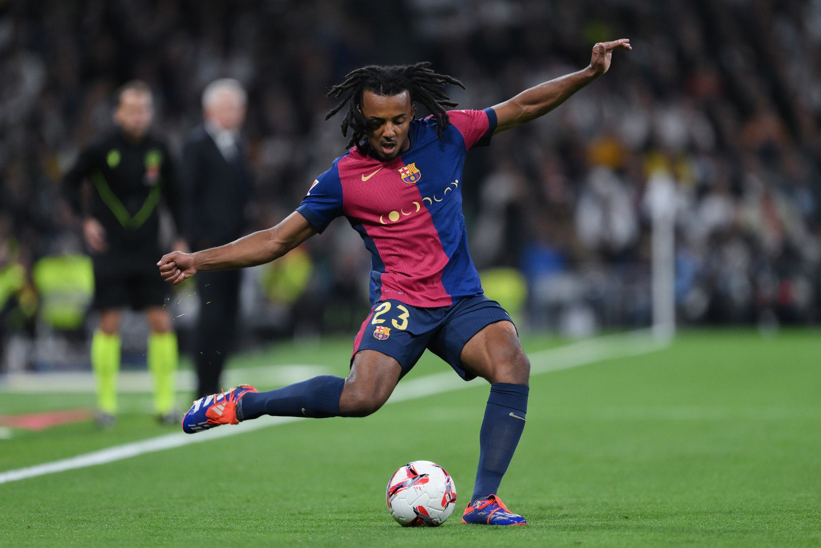 MADRID, SPAIN - OCTOBER 26: Jules Koundé of FC Barcelona runs with the ball during the LaLiga match between Real Madrid CF and FC Barcelona at Estadio Santiago Bernabeu on October 26, 2024 in Madrid, Spain.